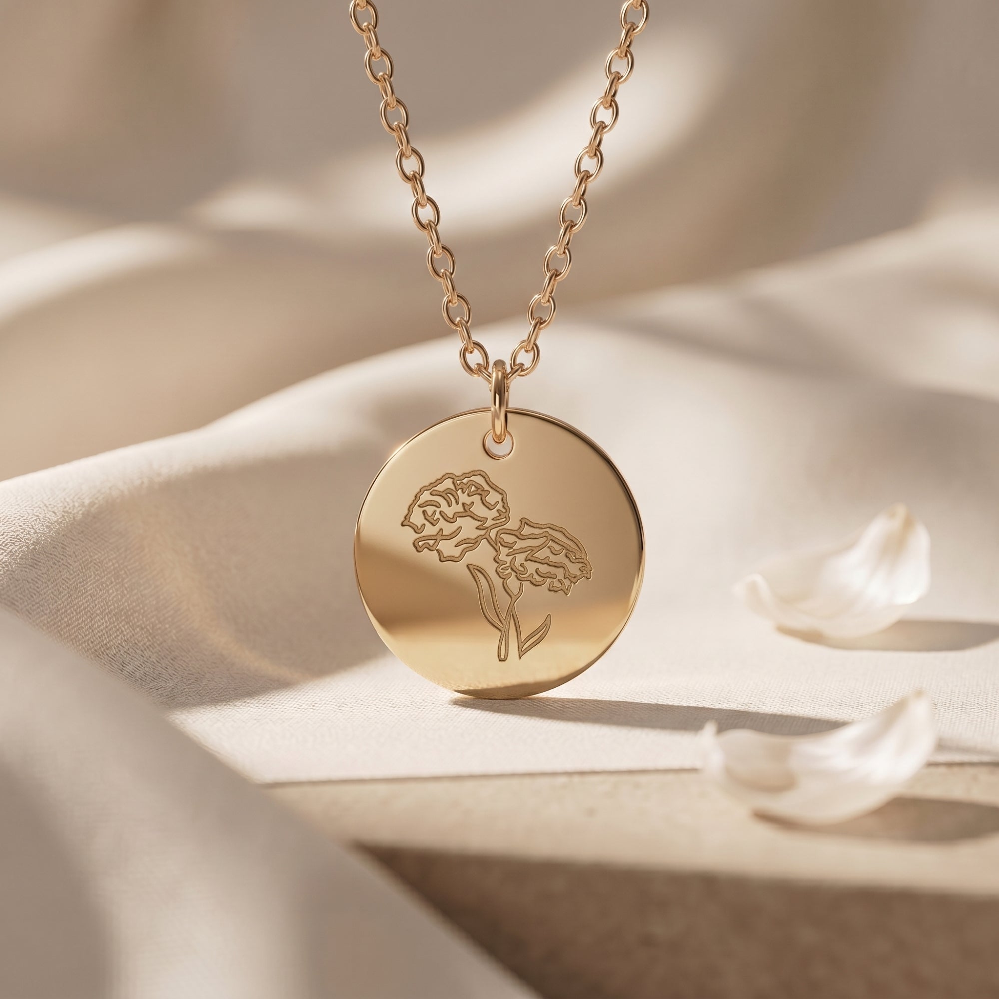 18K gold finish October birth flower necklace with an engraved cosmos on a dainty circular pendant.
