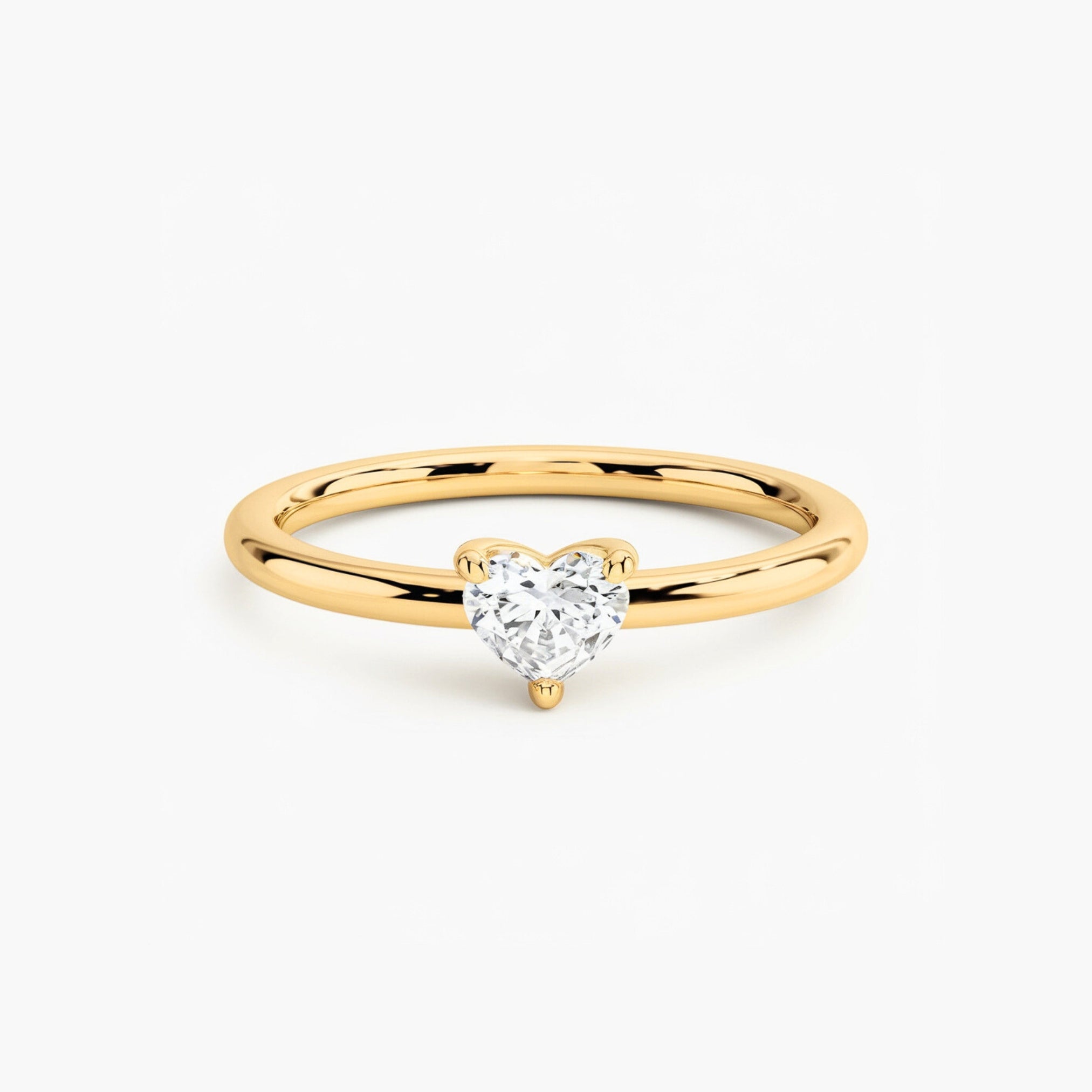A 14K solid gold ring featuring a 0.5 carat heart-cut Moissanite or Lab Grown Diamond.