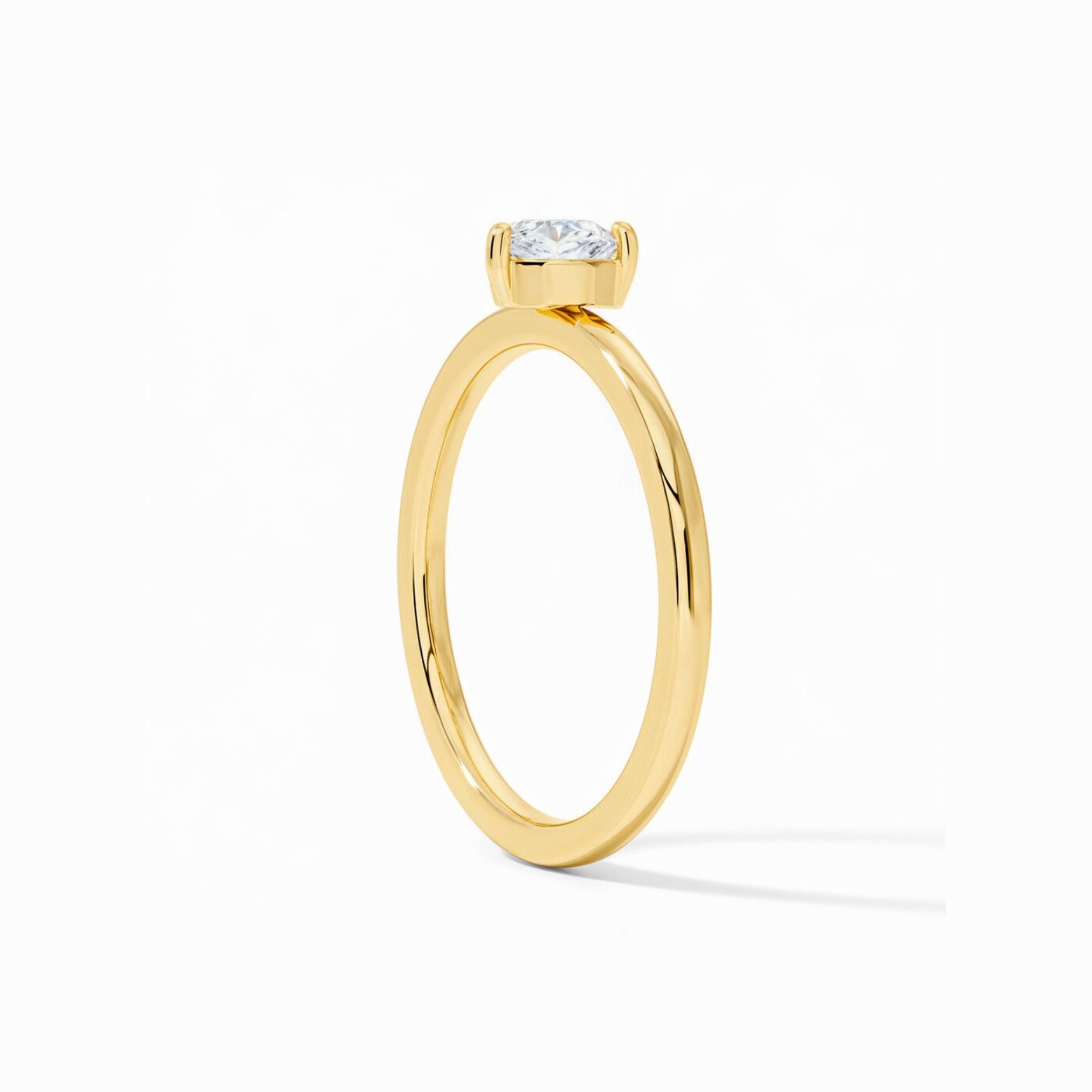 A 14K solid gold ring with a 0.5 carat heart-cut Moissanite or Lab Grown Diamond.
