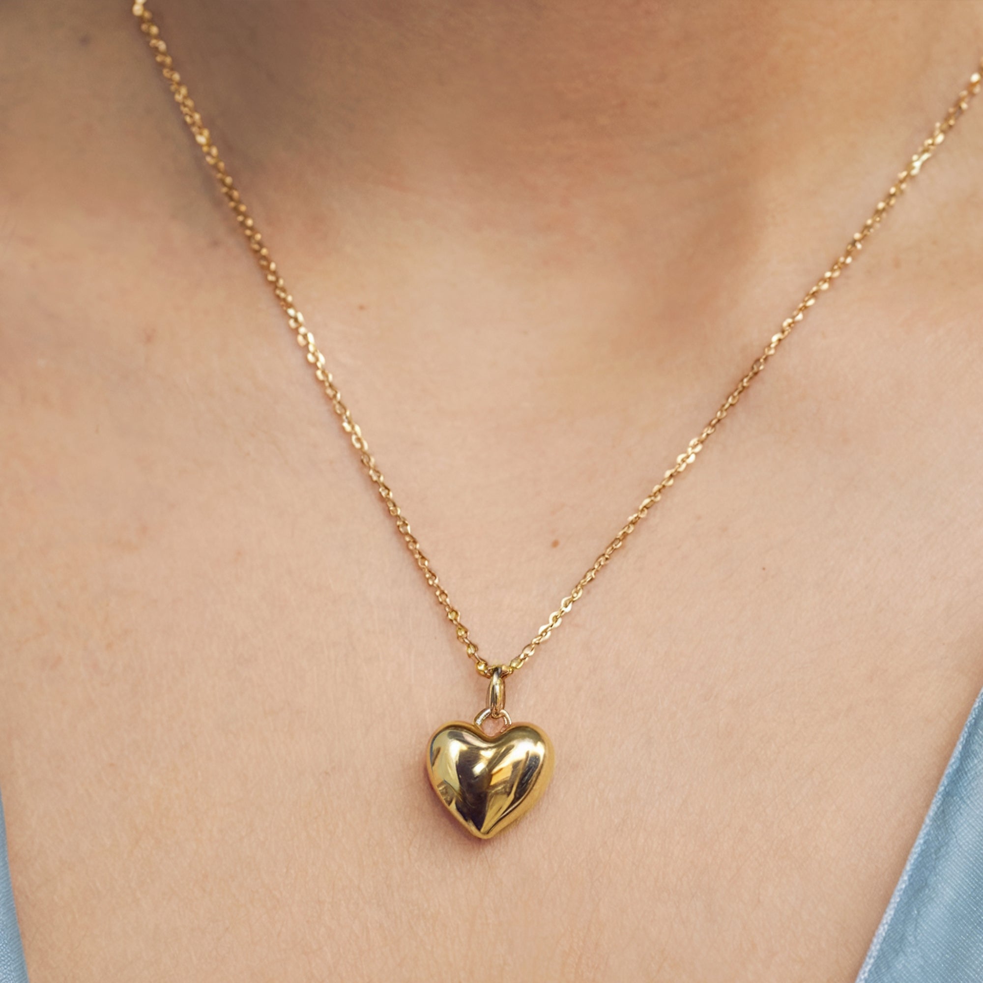 Solid gold Leva chunky heart necklace with adjustable chain, showcasing the pendant