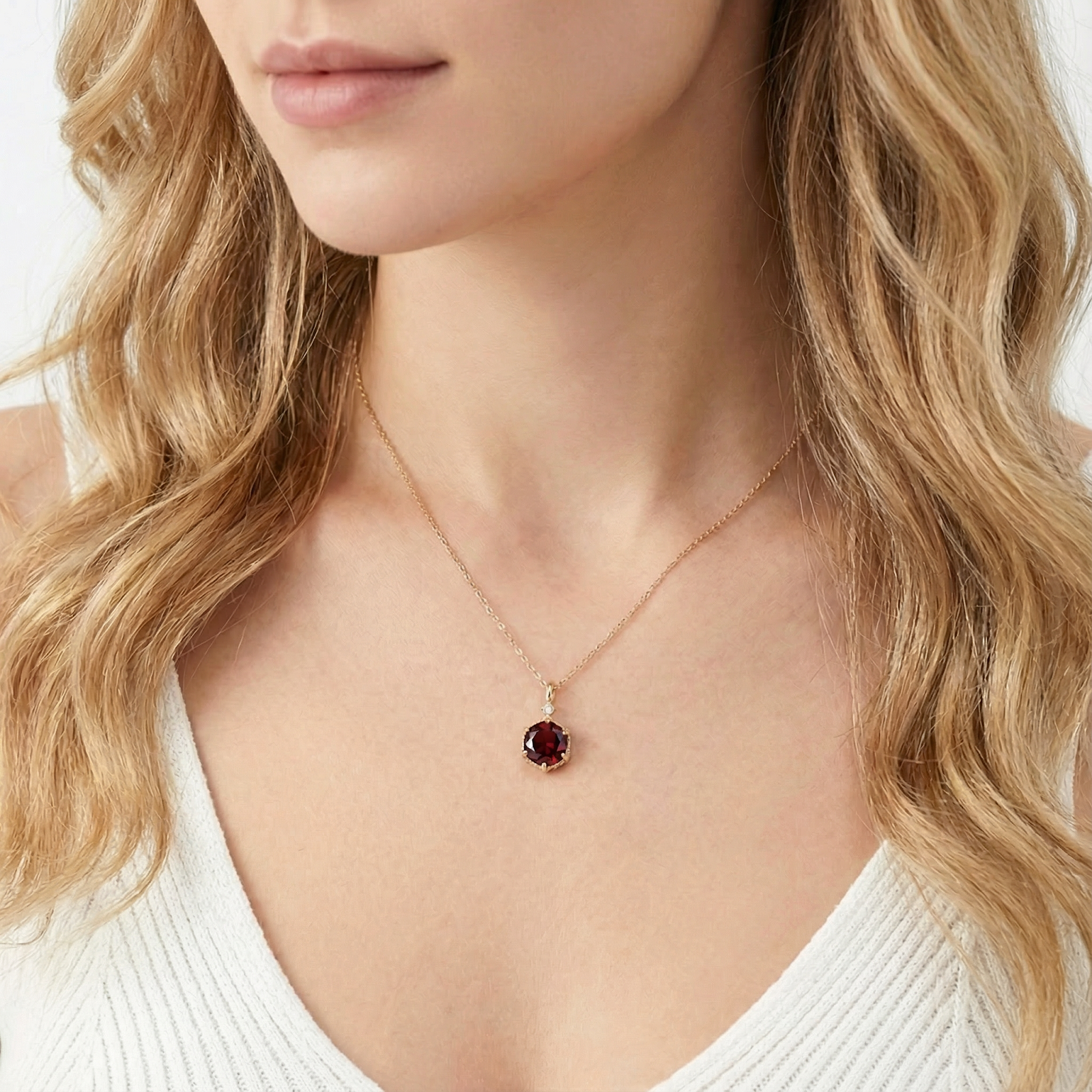 Model wearing the Kyra Hex 18K gold vermeil necklace featuring a January birthstone hexagon cut simulated garnet.