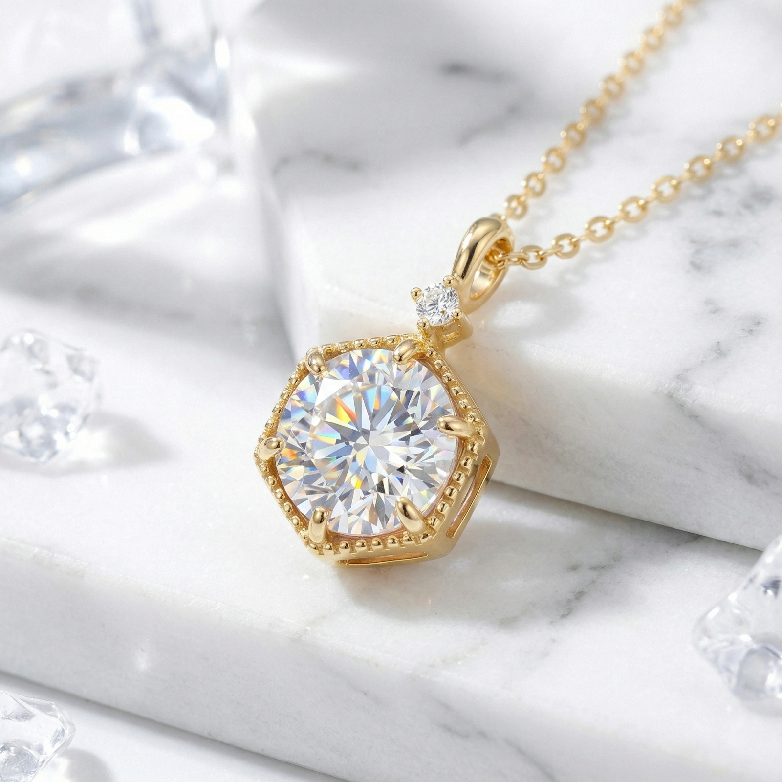 Angled view of the Hexa Radiant gold vermeil necklace with a round simulated diamond on a marble surface.