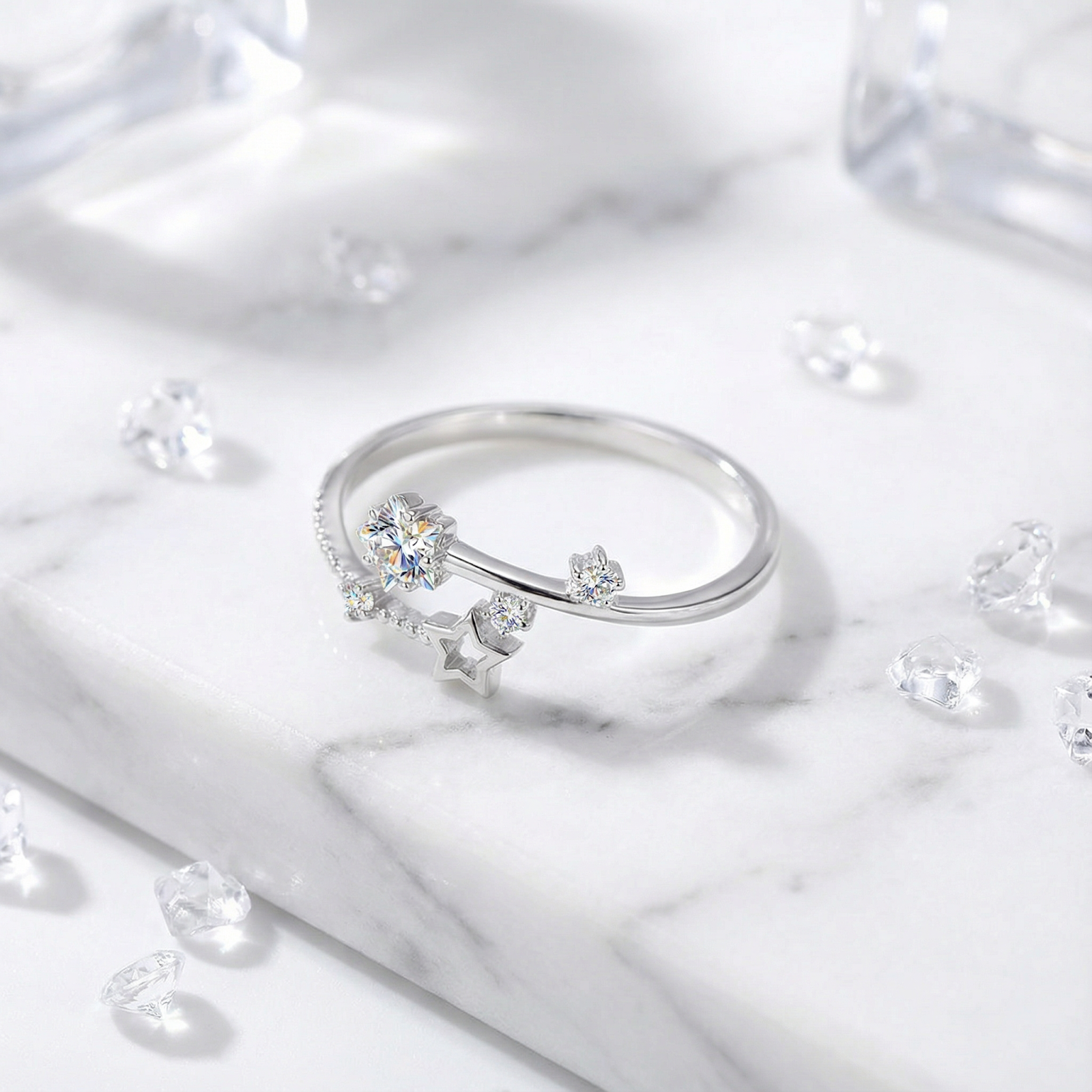 Angled view of the S925 sterling silver celestial bypass ring with round cut zirconia stars on marble.