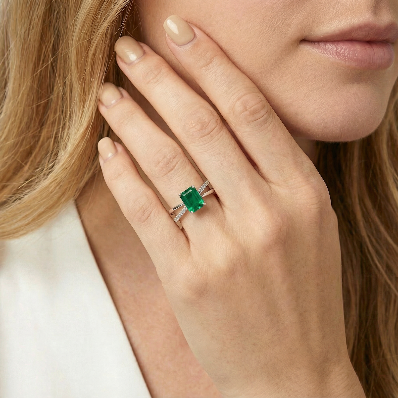 Model wearing the S925 sterling silver Sylvana Twist Ring featuring a green emerald cut simulated emerald.