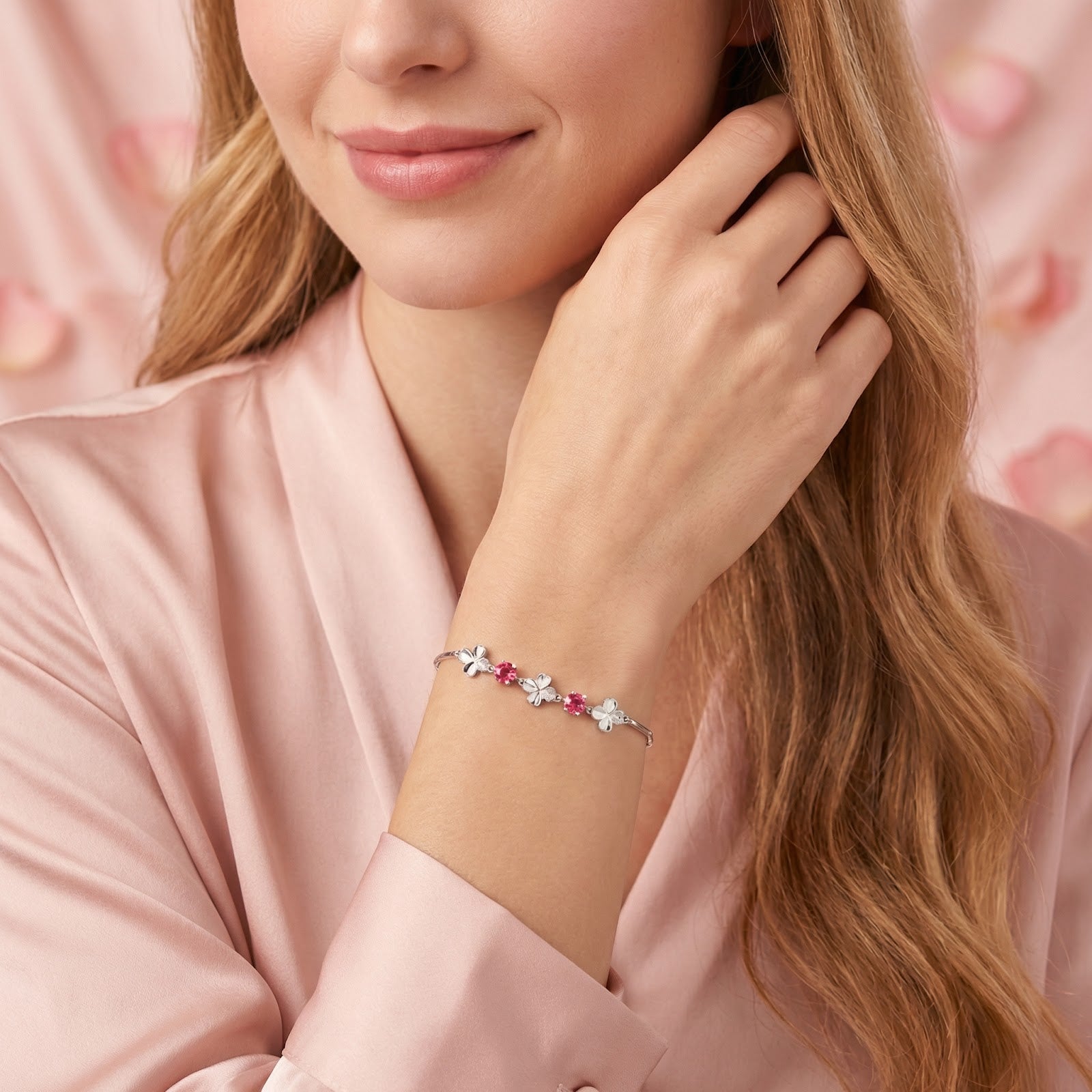 Woman wearing the sterling silver clover bracelet with pink tourmaline stones on her wrist.