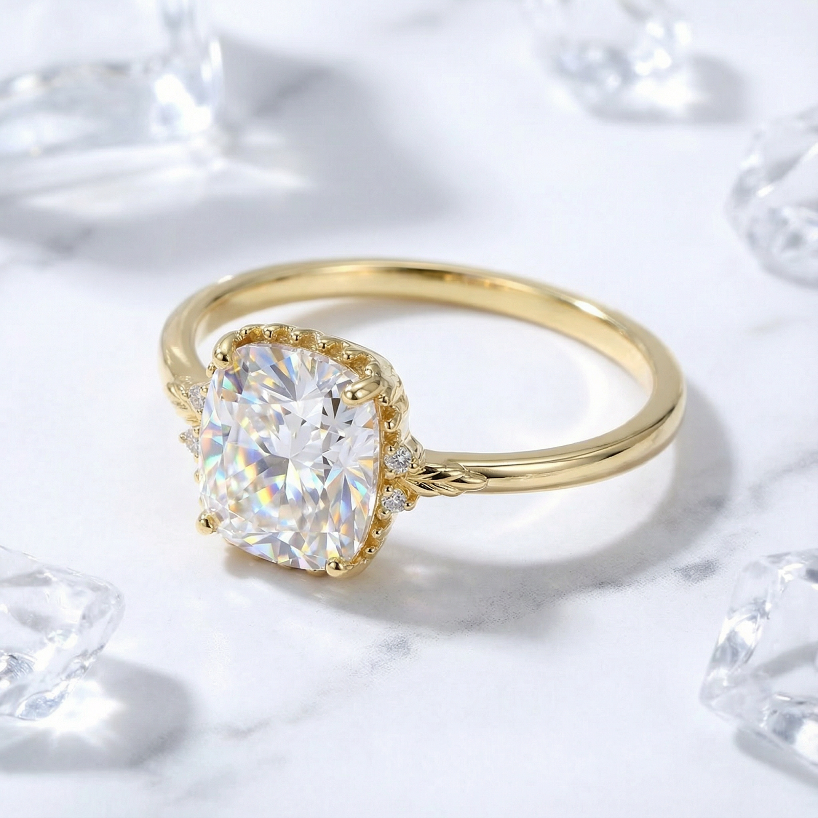 Cushion cut simulated diamond solitaire ring in 18K gold vermeil on a marble surface with ice props.