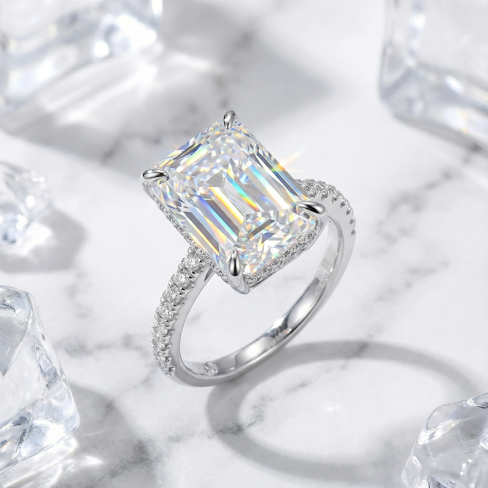 Angled view of the Hespera radiant cut simulated diamond ring in sterling silver with a pavé band.