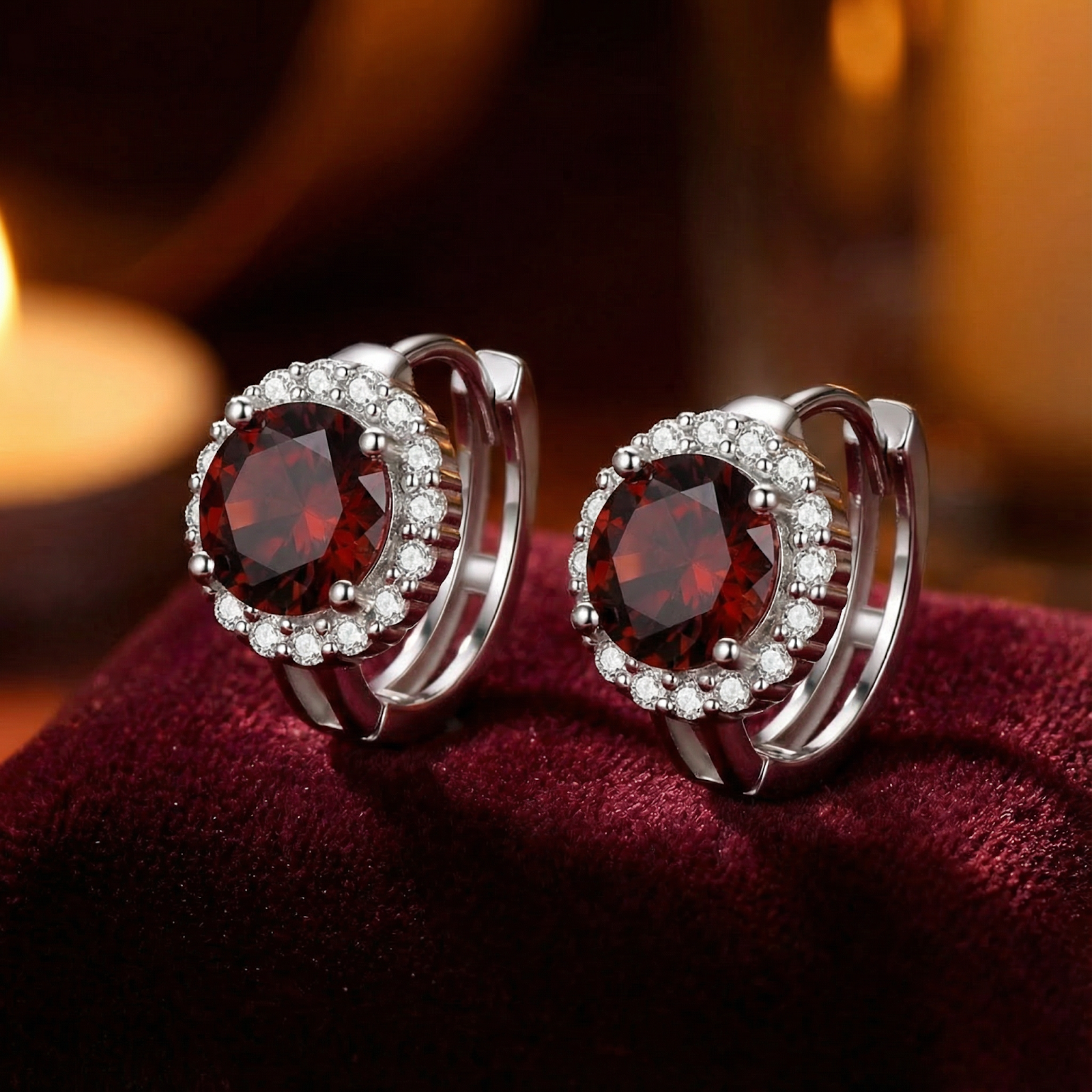Detailed view of S925 sterling silver halo stud earrings with round simulated garnets showing the hinged setting.