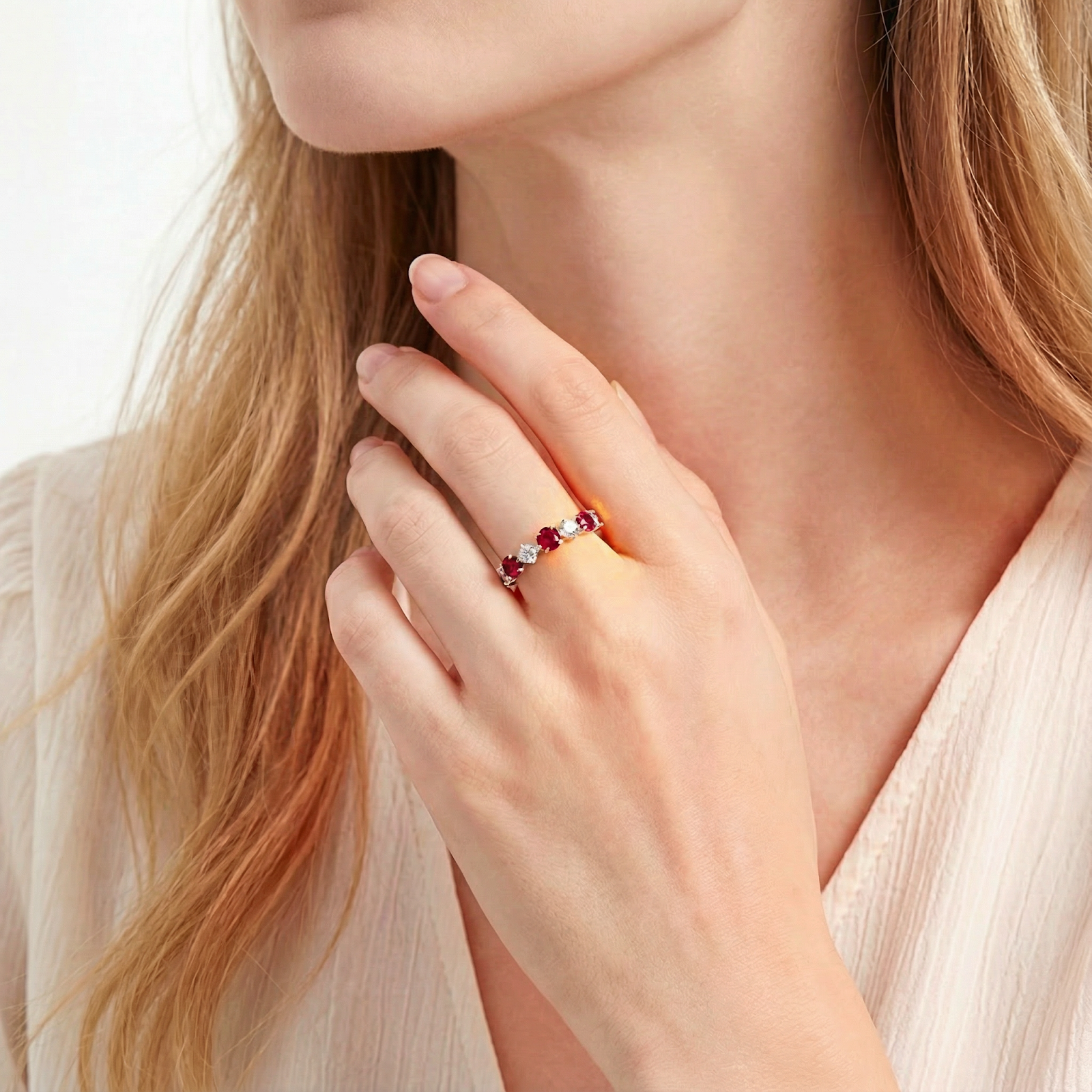 Model wearing the Rubielle S925 sterling silver eternity ring with red and clear stones on her ring finger.