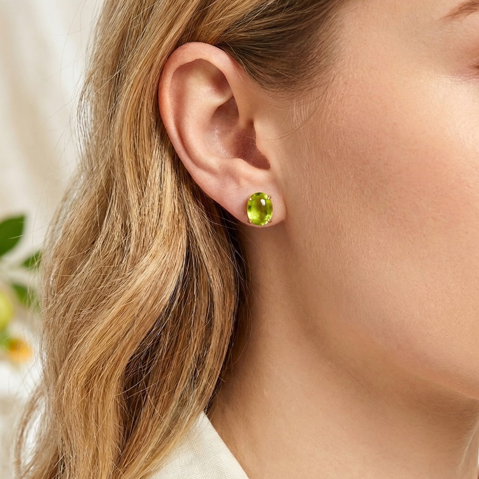 Model wearing the Verdelle August birthstone simulated peridot cabochon stud earring in 18K gold vermeil.