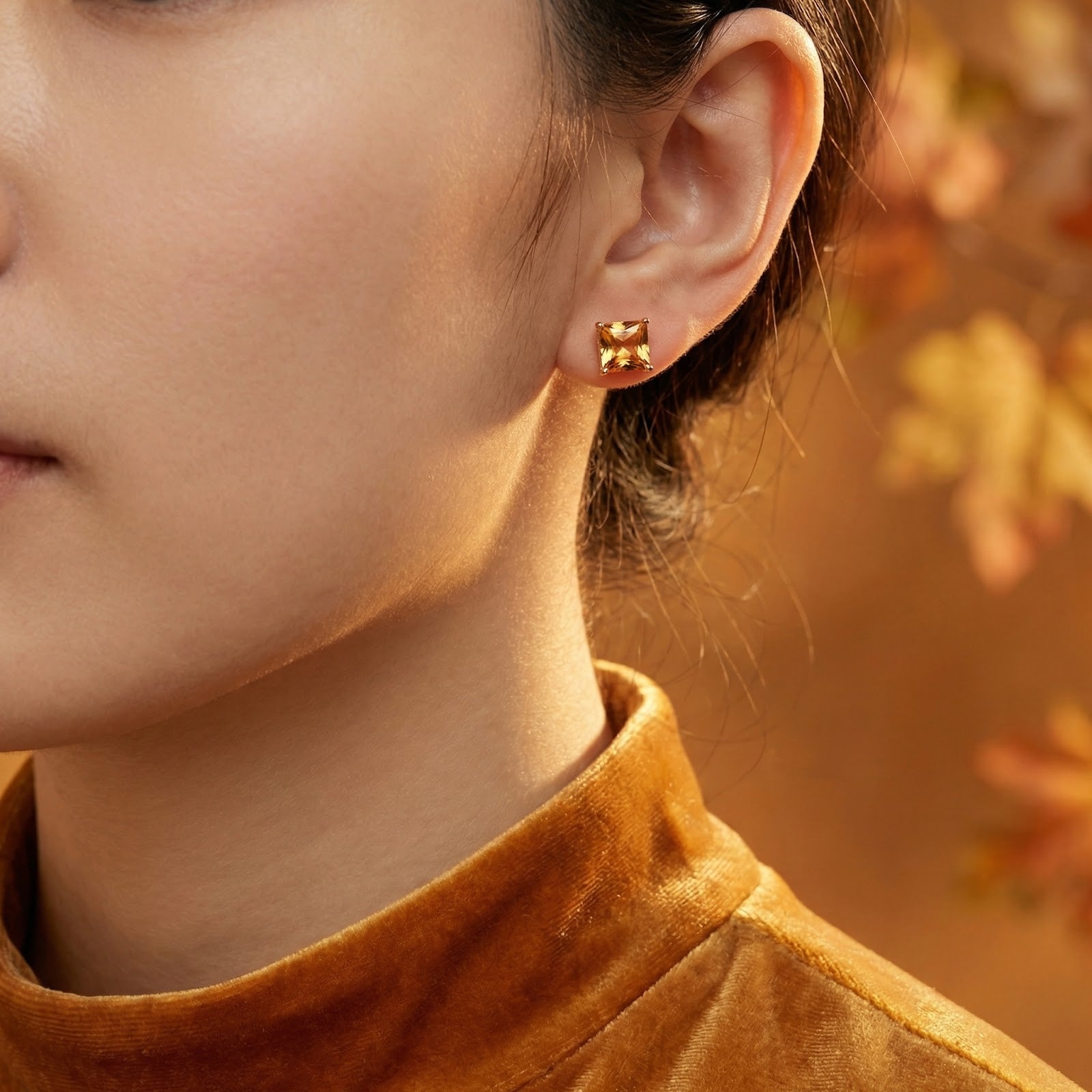 Model wearing the Calysia square simulated topaz stud earring in 18K rose gold vermeil.