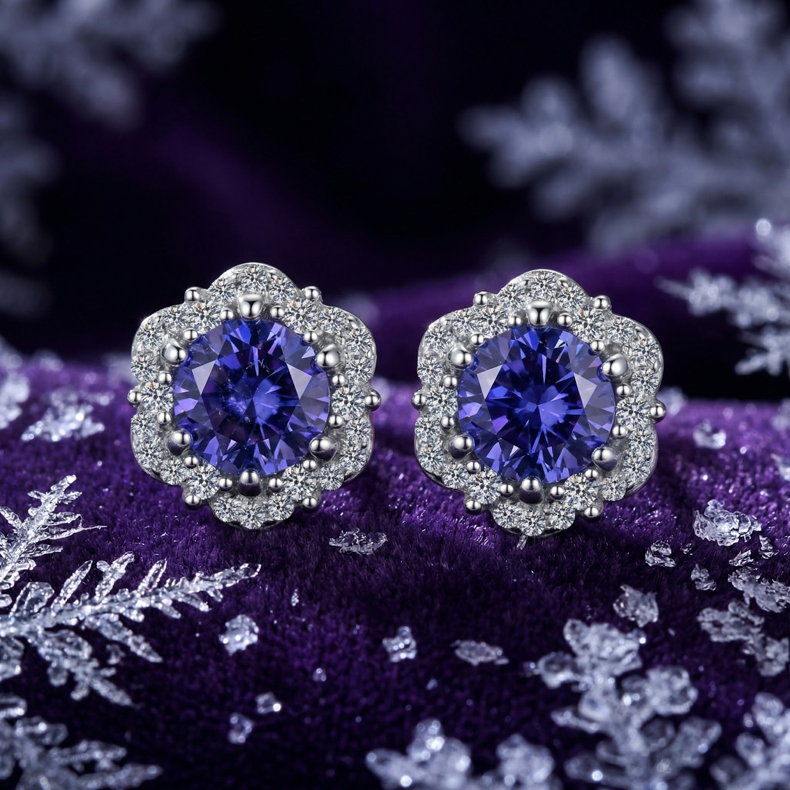 Sidraea Blossom sterling silver halo earrings with round simulated tanzanite on a winter-themed purple background.