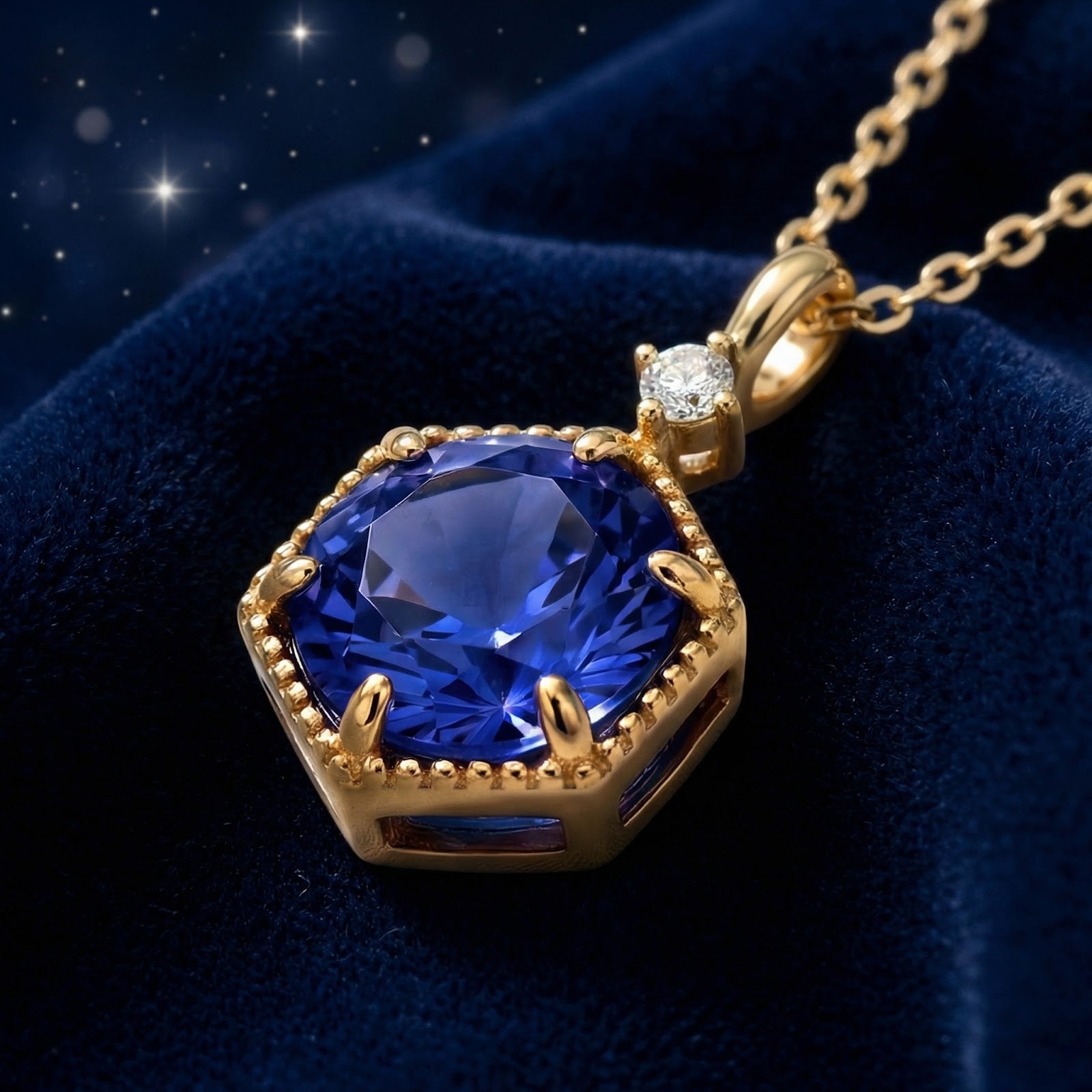 Angled macro view of the royal blue hexagon simulated sapphire necklace in 18K gold vermeil on velvet.
