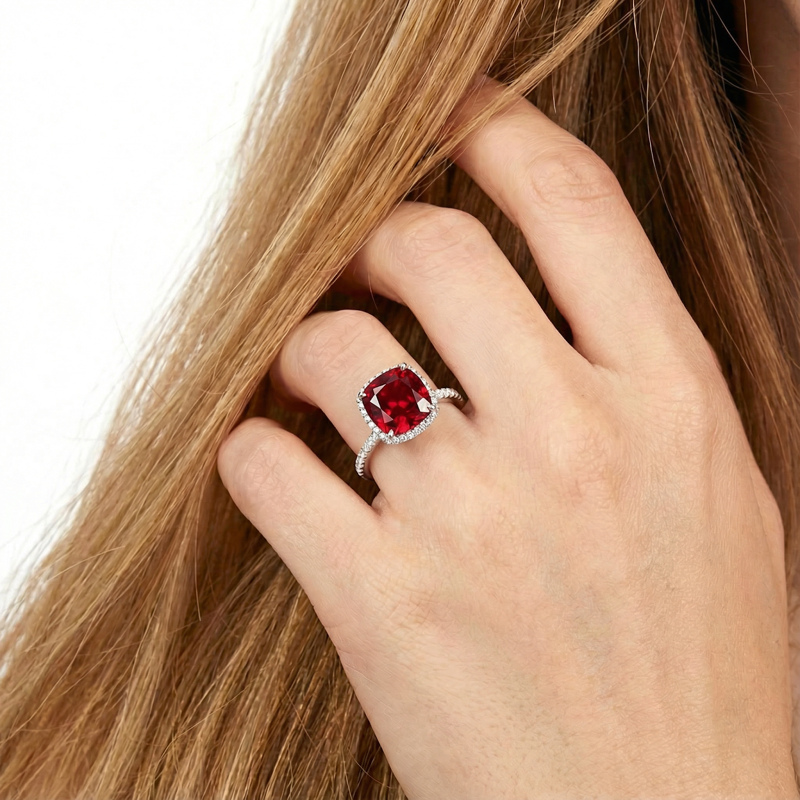 Close-up of the cushion-cut simulated ruby sterling silver ring on a hand showing its size and scale.