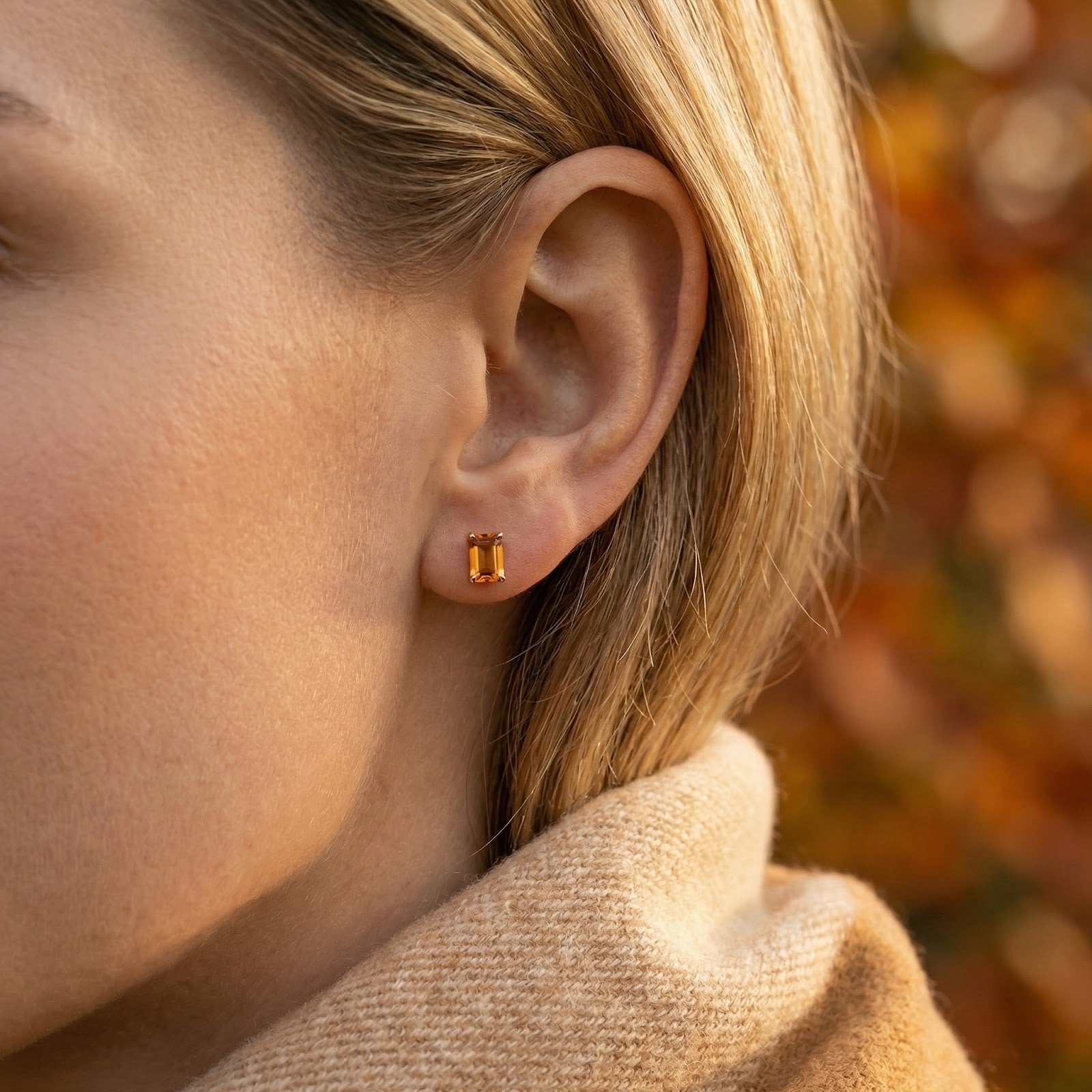 Side view of a model wearing the Aurellise baguette simulated topaz stud earring in 18K gold vermeil.