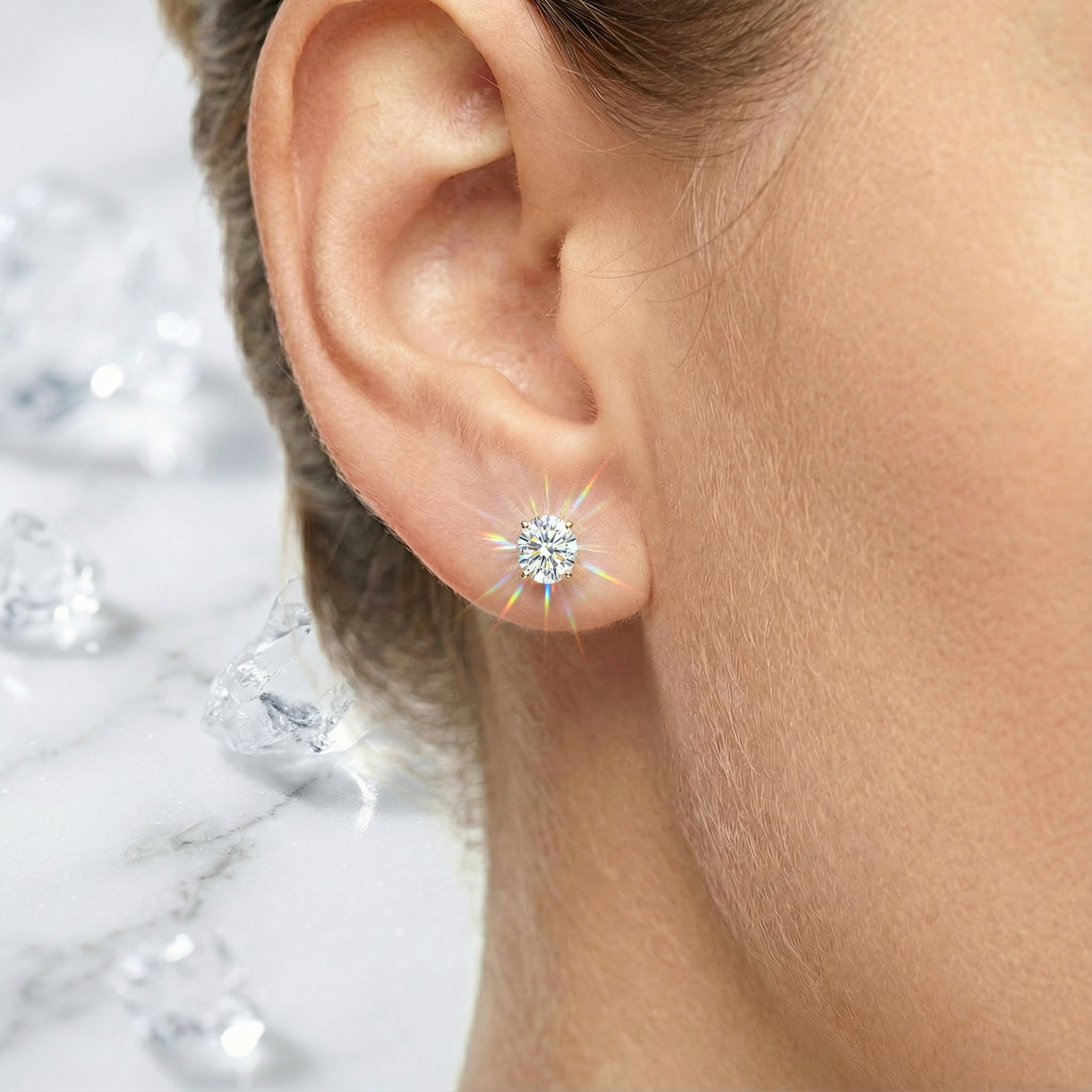 Detailed view of an 18K gold vermeil oval zirconia stud earring worn on an ear.