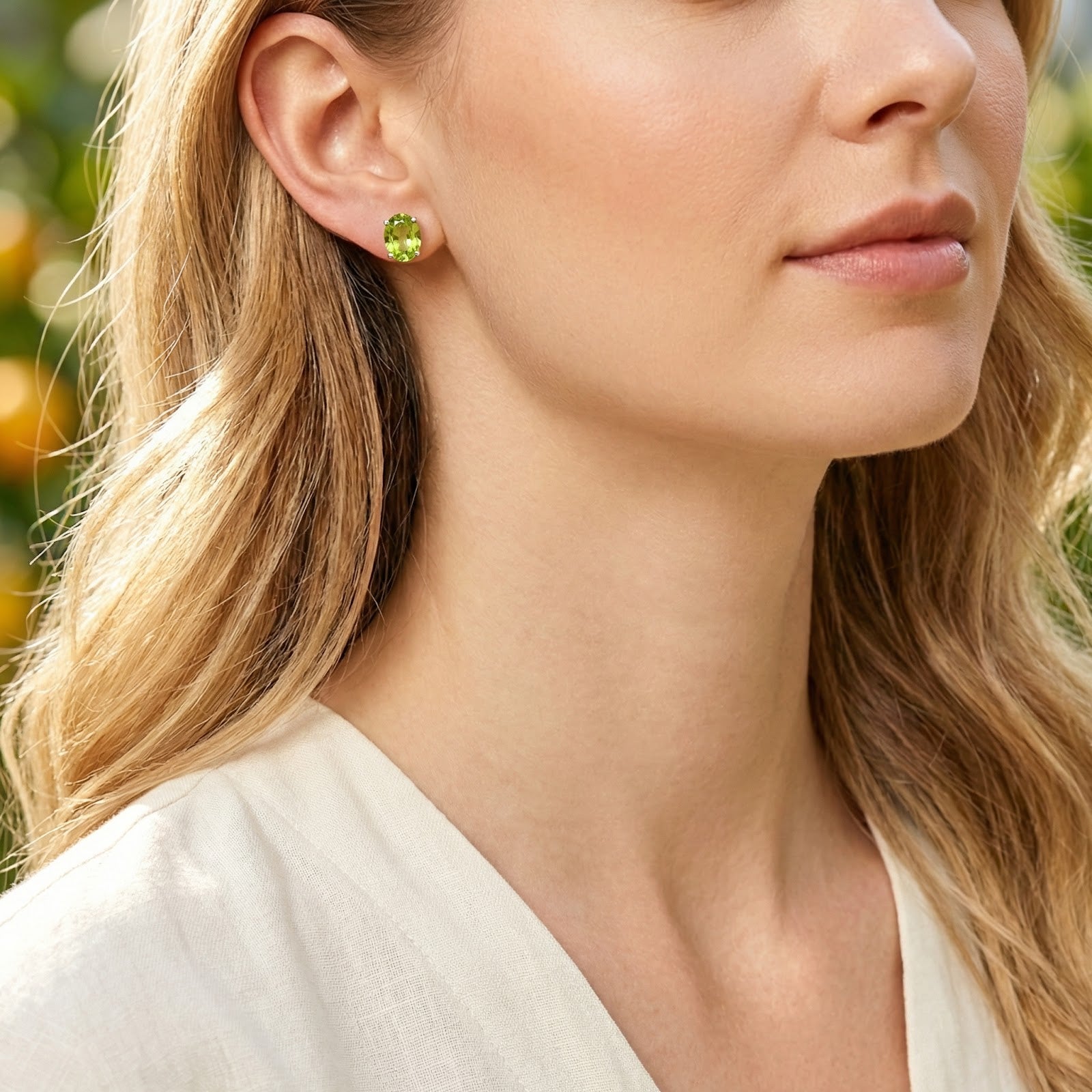 Model wearing the Arisala oval-cut simulated peridot stud earrings in S925 sterling silver with a white shirt.