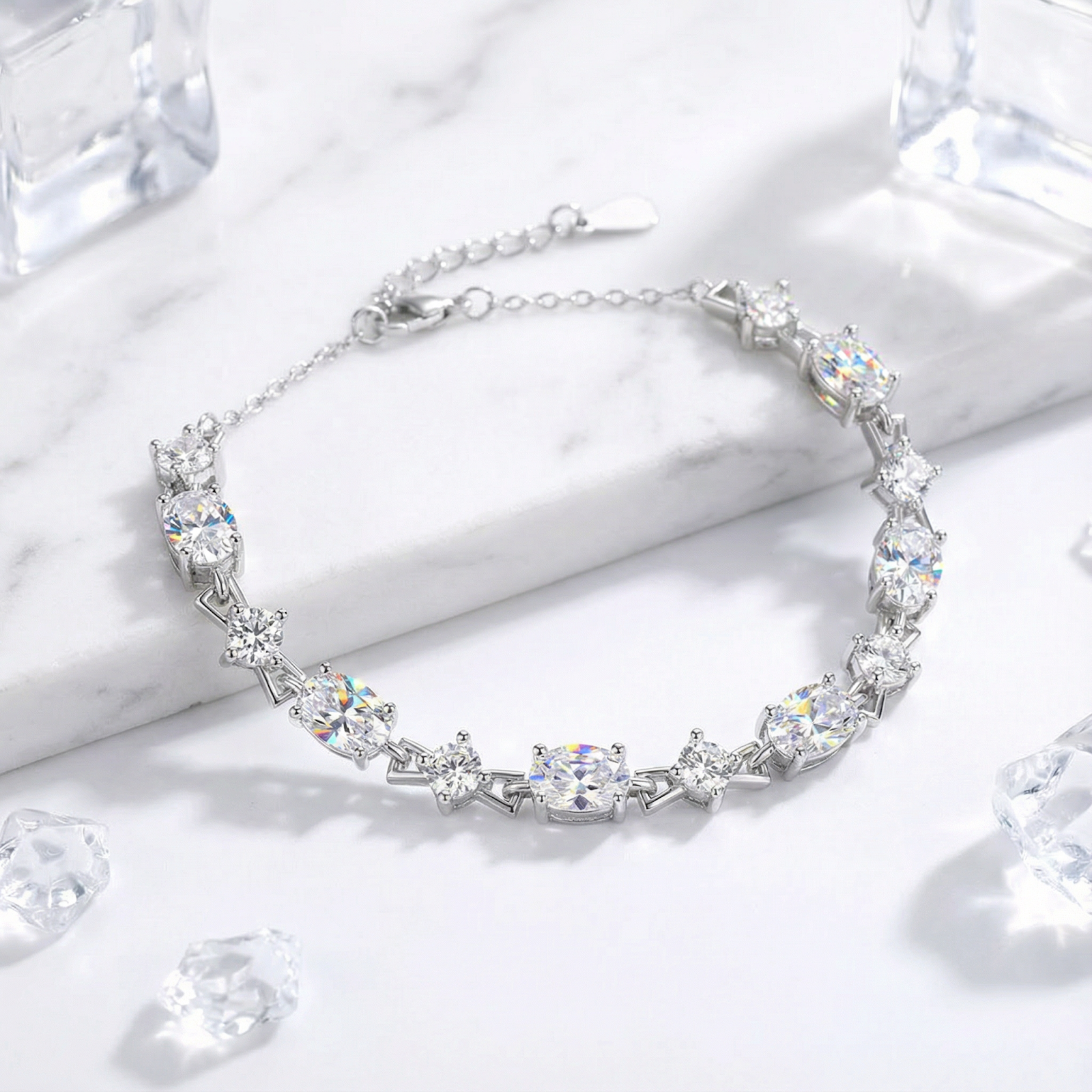 S925 sterling silver bracelet featuring alternating round and oval-cut zirconia stones on a marble surface.