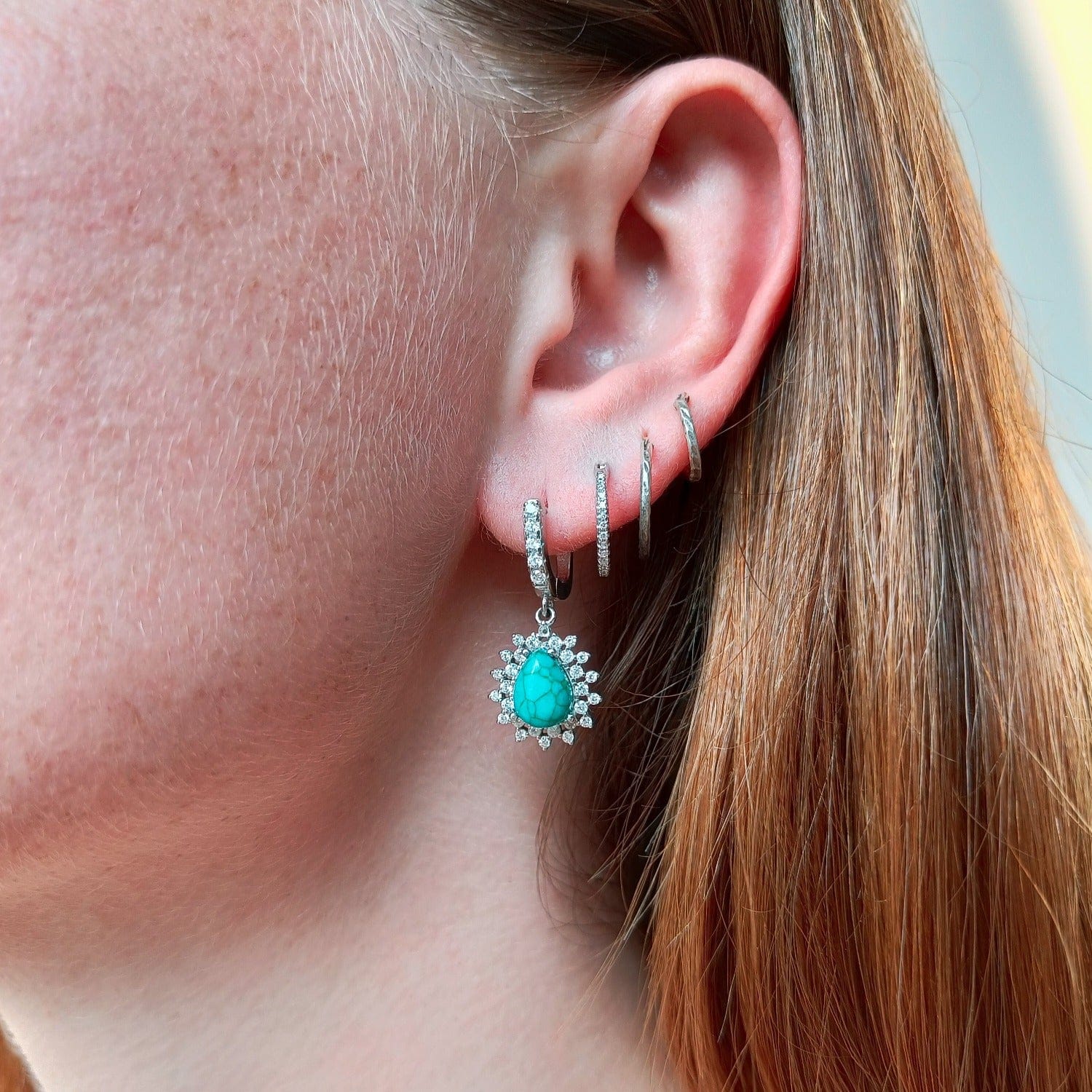 Blue Lagoon Turquoise Earrings featuring turquoise stones set in S925 sterling silver natural view on a model in shaded lighting