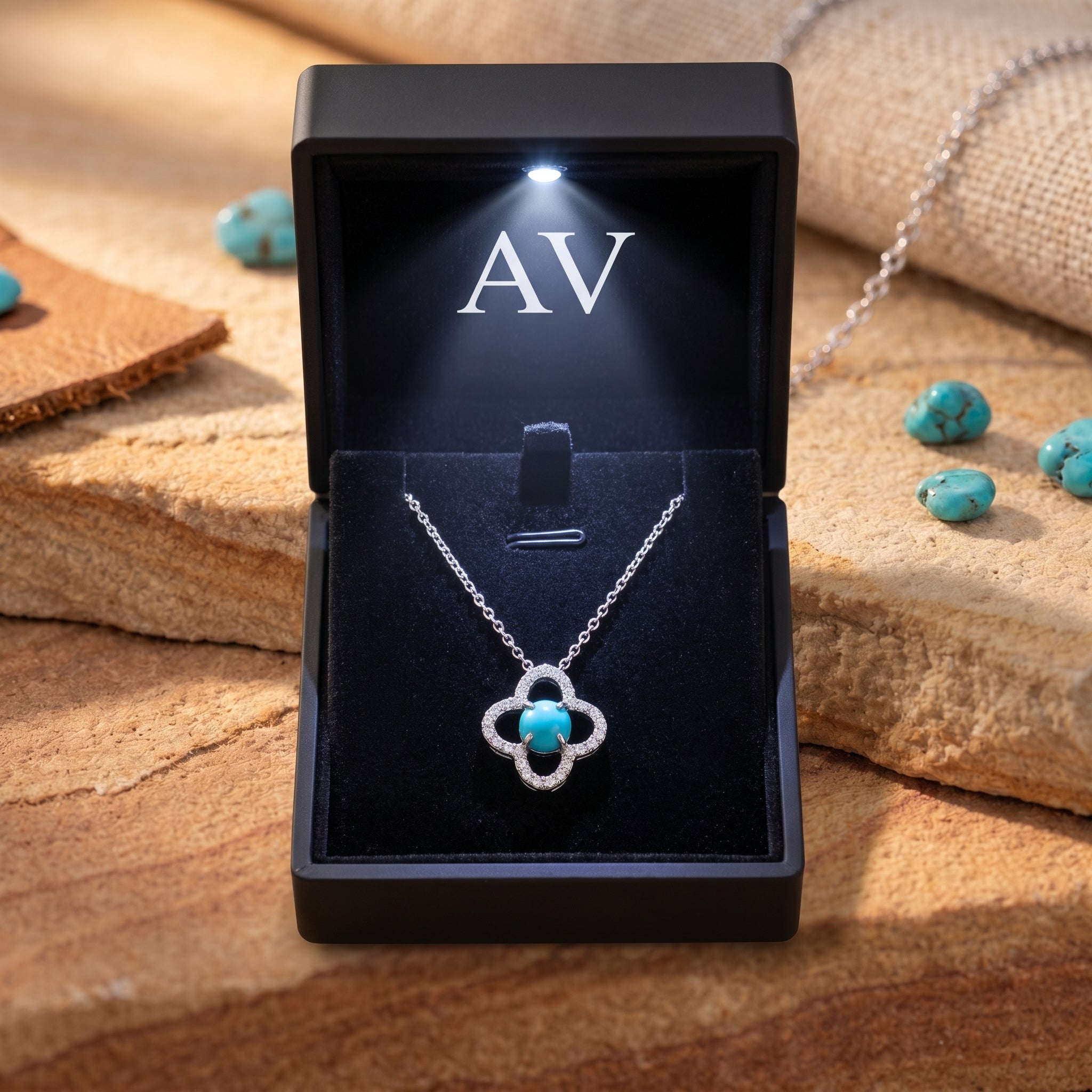 Silver turquoise quatrefoil necklace inside a black LED-lit jewelry gift box.