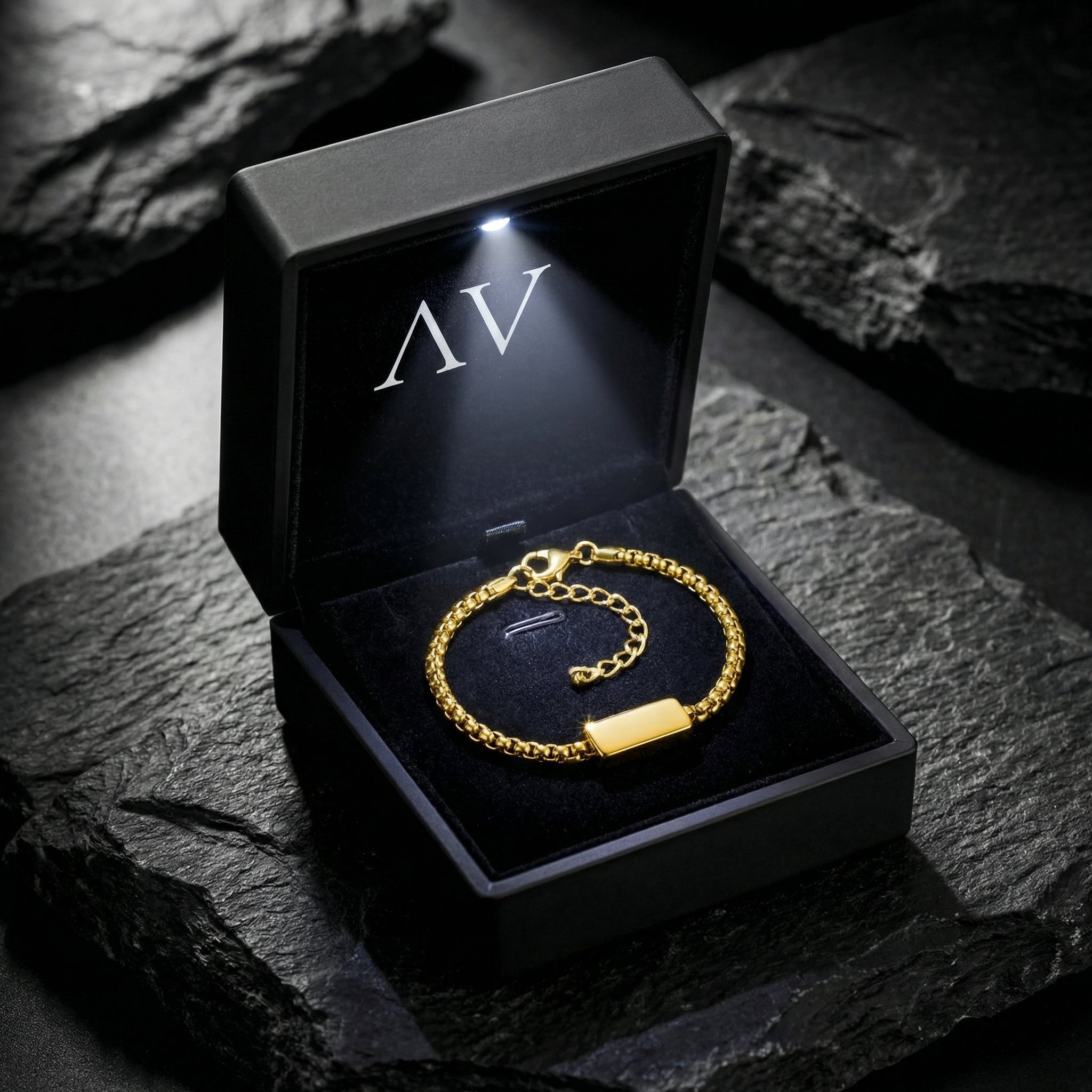 Gold stainless steel 5mm Cipher ID bracelet inside a premium black LED-lit jewelry presentation box.