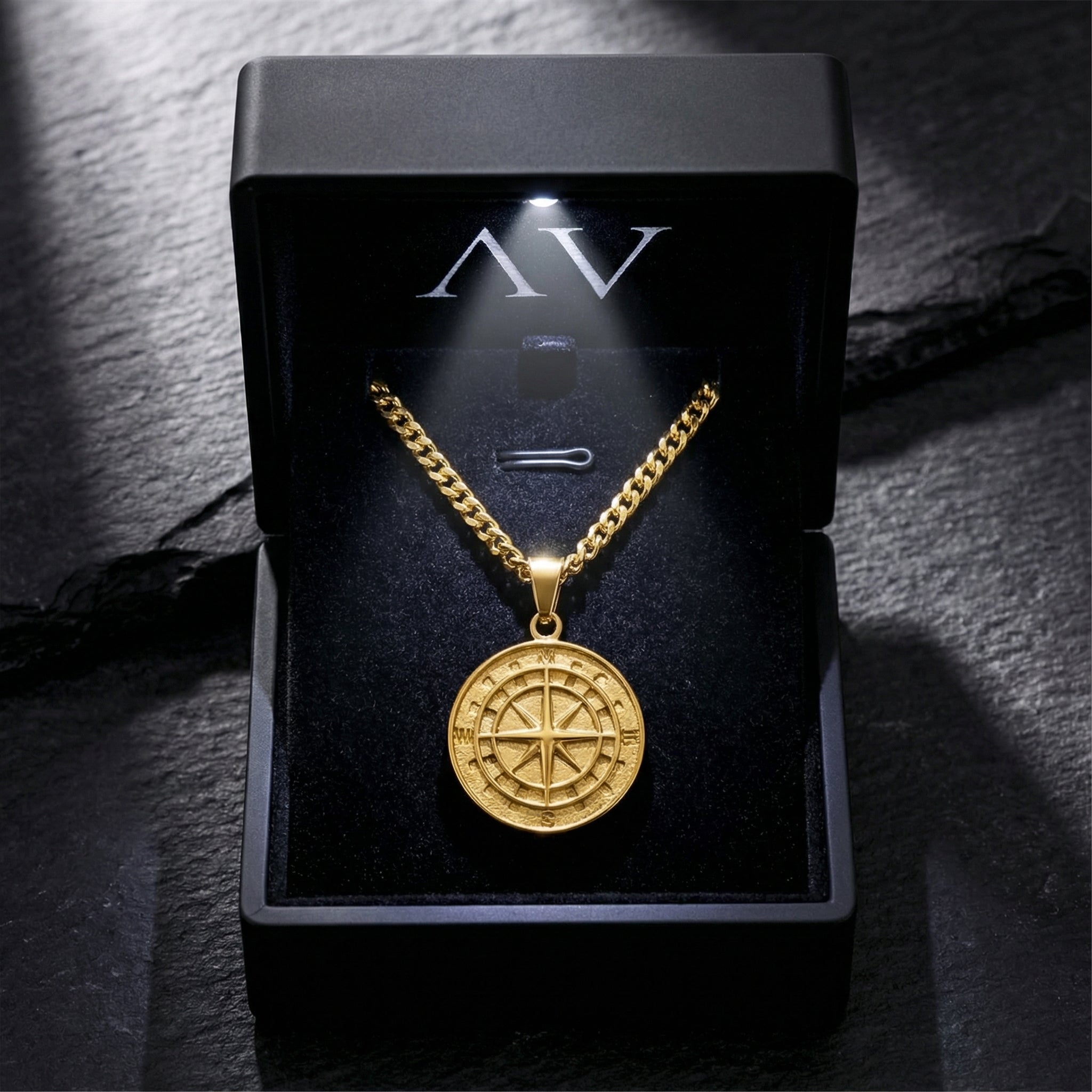 Gold stainless steel Voyager compass pendant necklace displayed in a black LED-lit jewelry gift box.