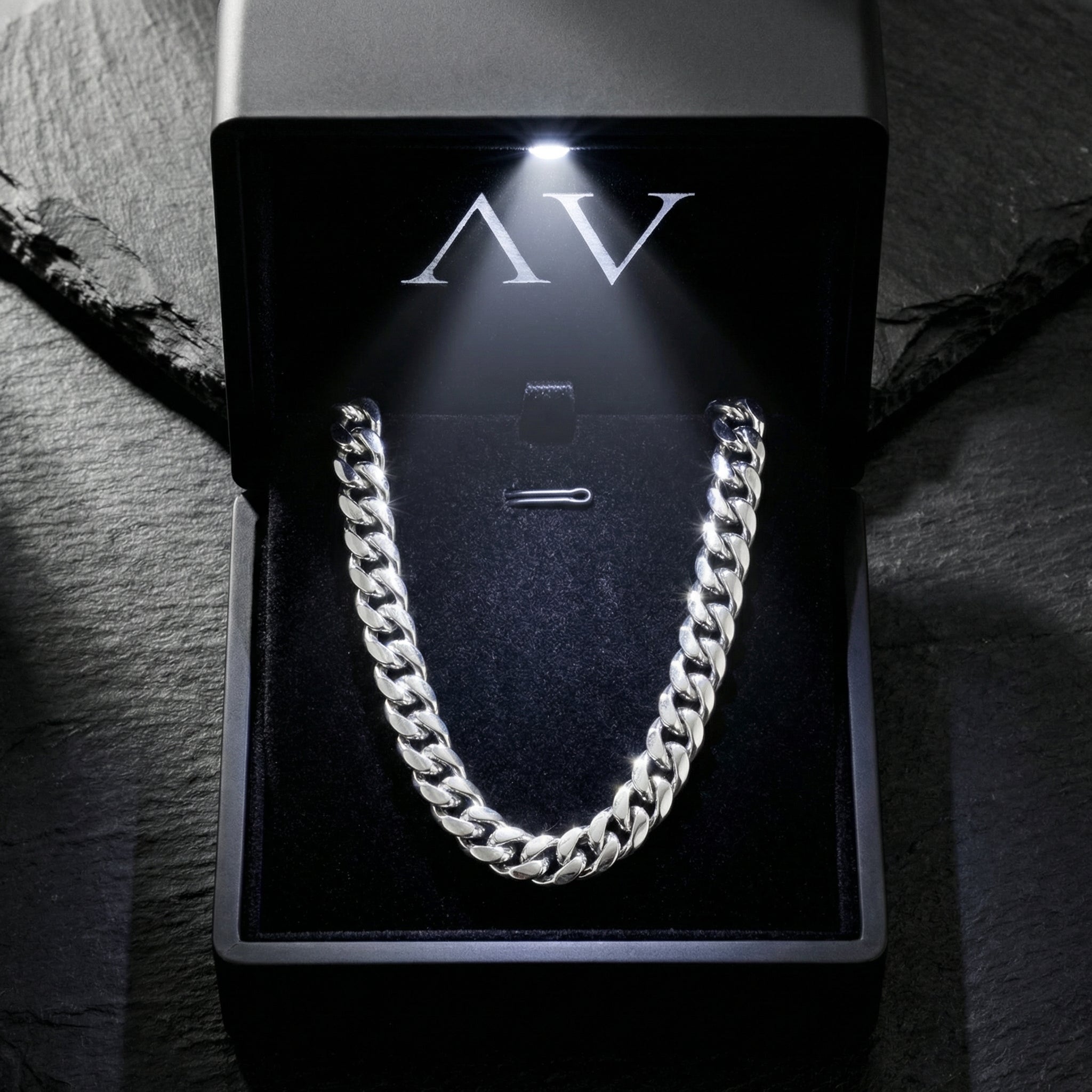 Silver 8mm stainless steel Cuban link chain inside a premium black LED-lit presentation box.
