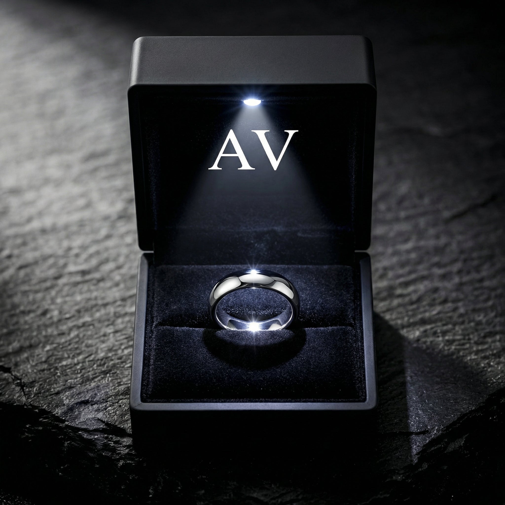 The Minimalist Ring in silver stainless steel inside a black LED-lit jewelry presentation box.