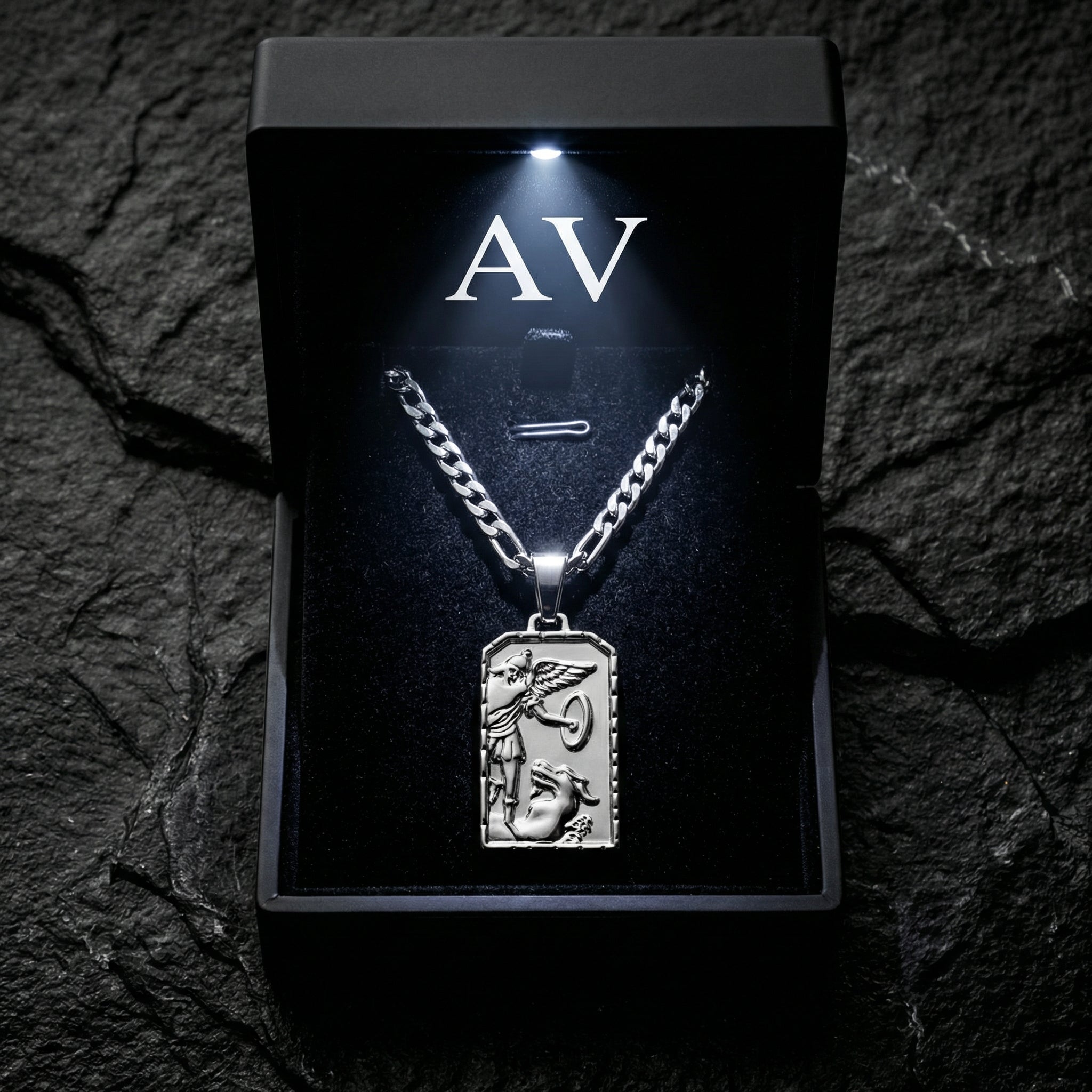 Silver St. Michael's Victory pendant displayed in a black LED-lit jewelry box with AV branding.