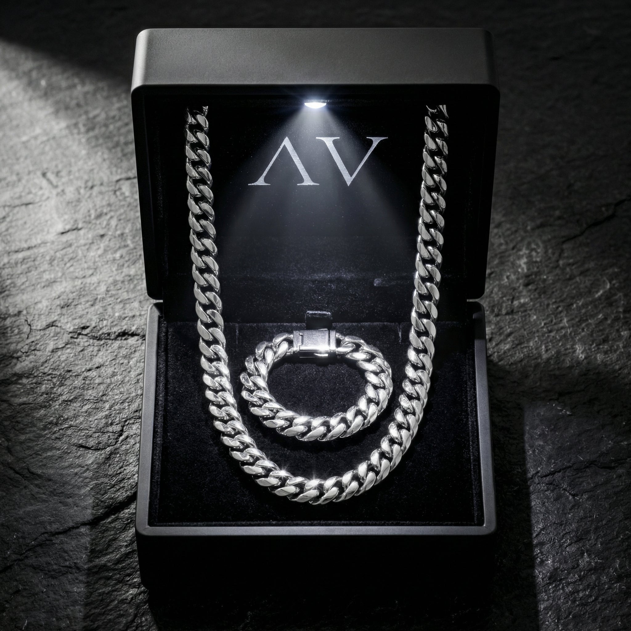 Polished silver 10mm stainless steel Cuban link chain and bracelet set inside a black LED-lit presentation box.
