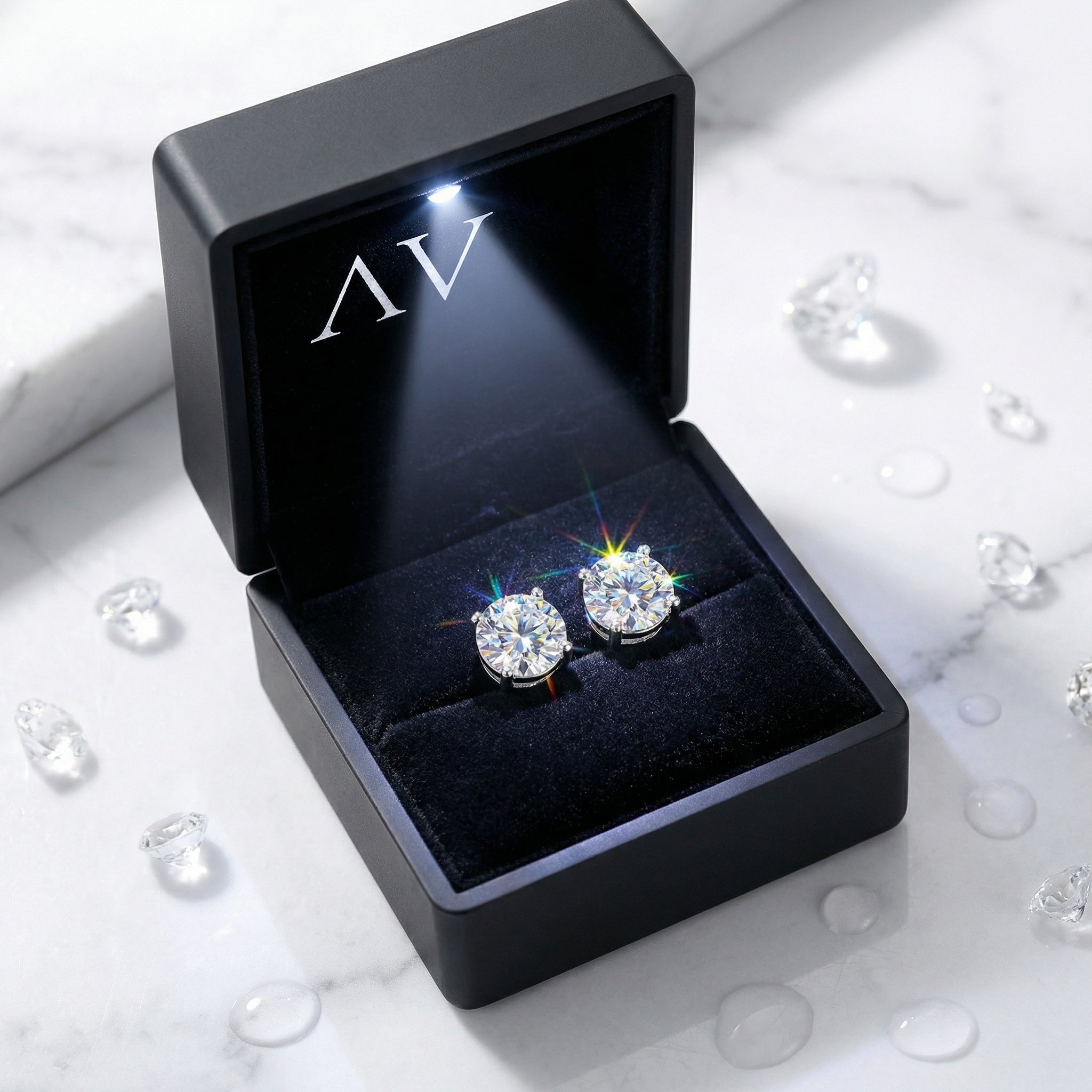 Round-cut Zirconia stud earrings in a premium black LED-lit jewelry presentation box.