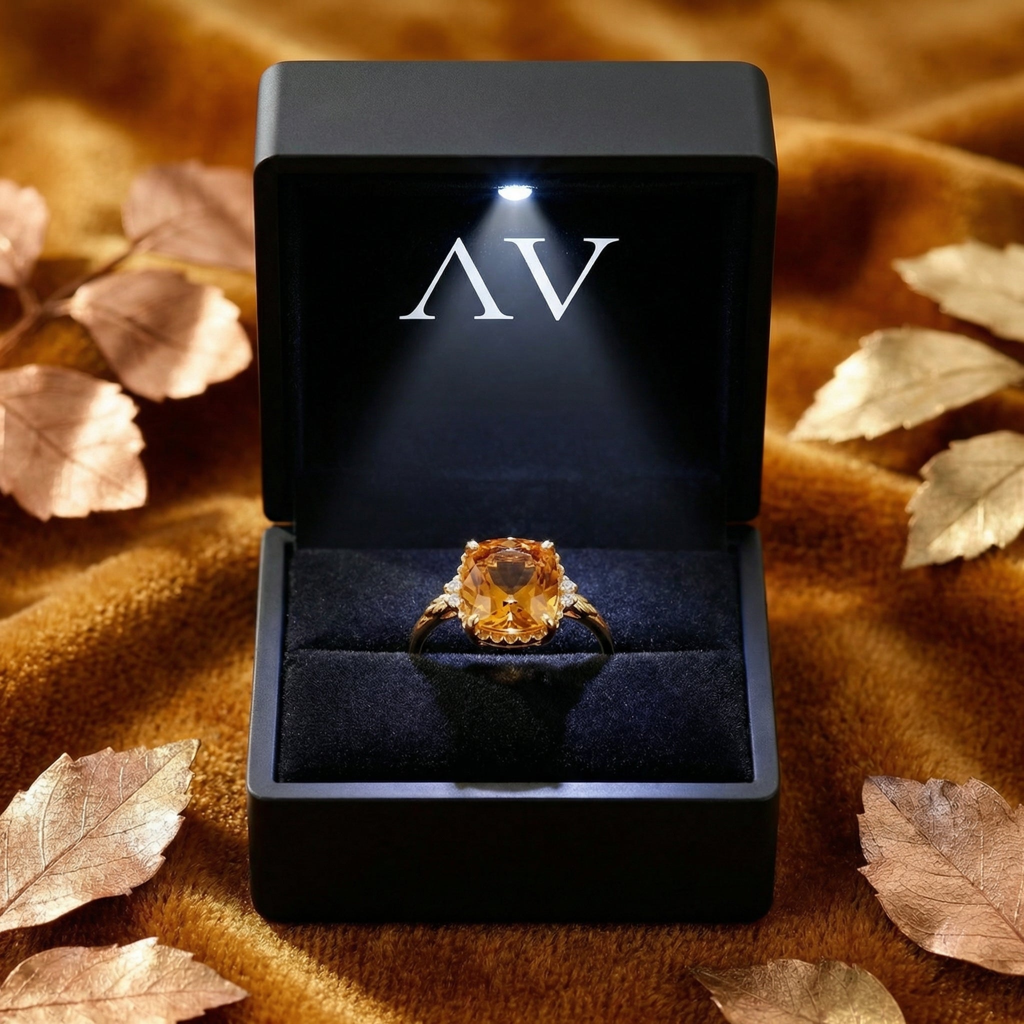 The Calysienne 18K gold vermeil cushion-cut topaz ring inside a black LED-lighted presentation box.
