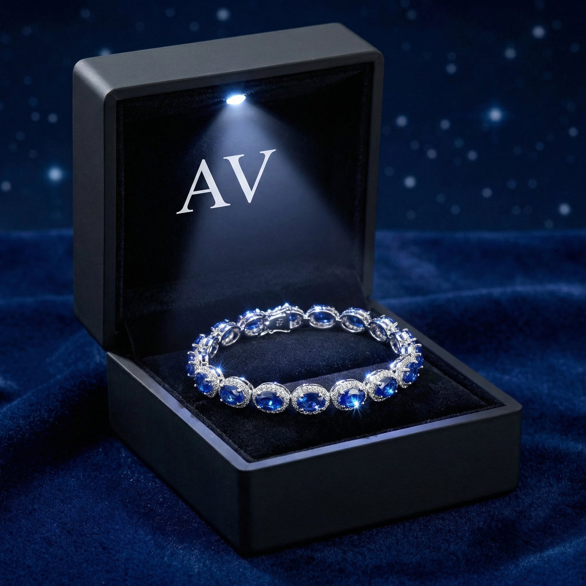 Sterling silver simulated sapphire halo bracelet presented in a lighted black jewelry gift box.