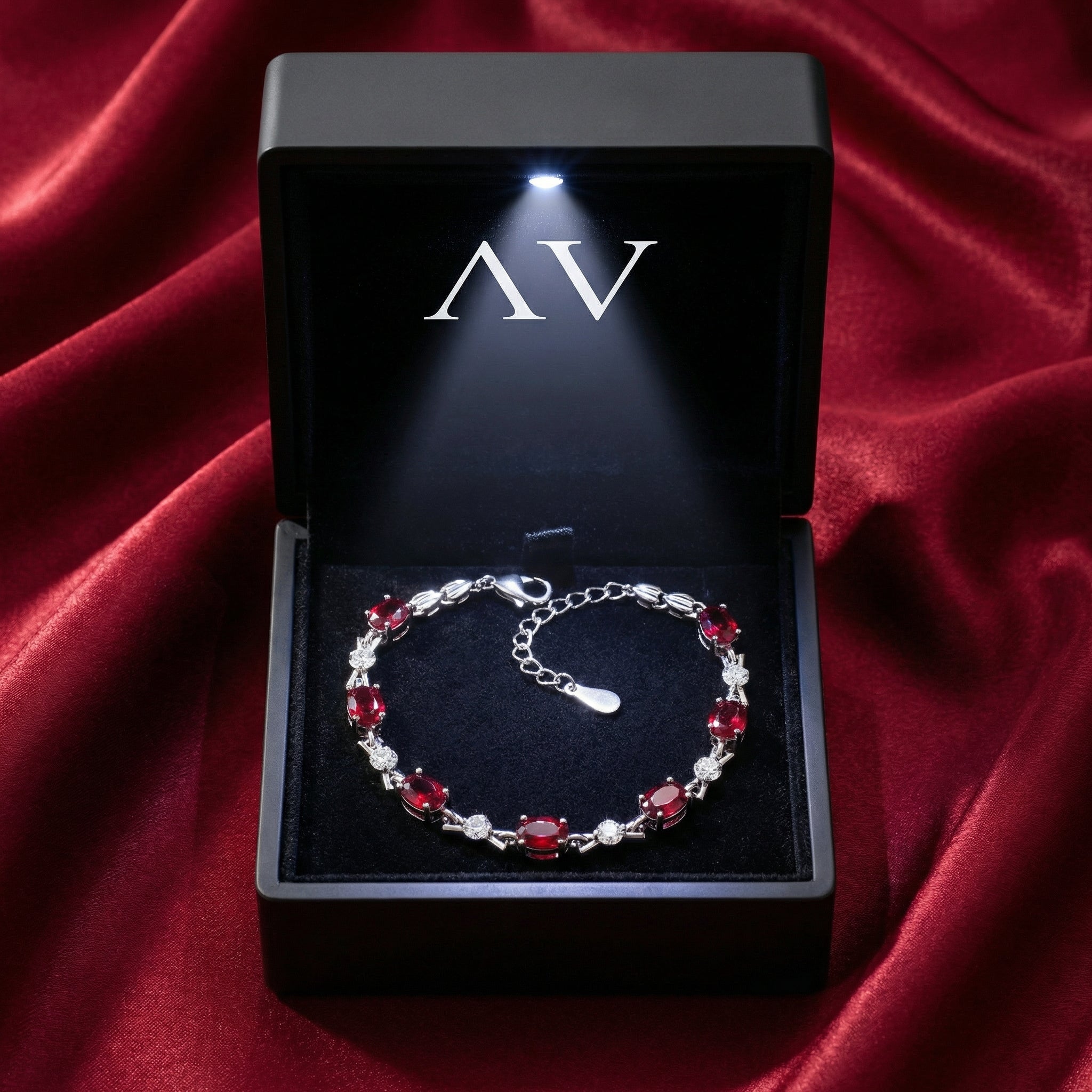 Vivara simulated ruby tennis bracelet presented in a black LED-lit gift box on red satin.