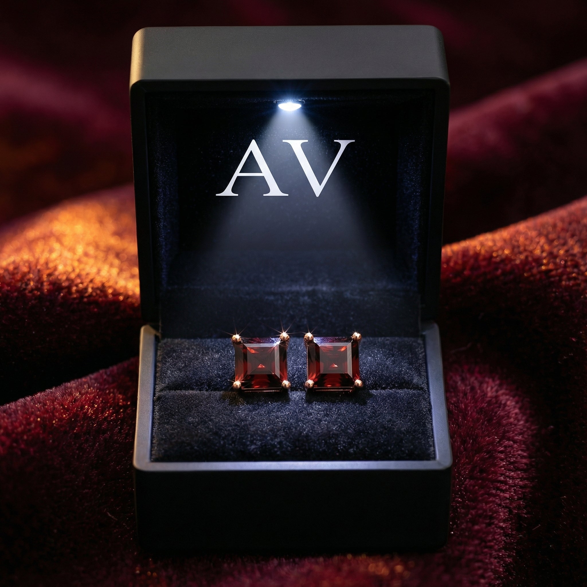 Square cut simulated garnet earrings in rose gold vermeil presented in a black LED-lit jewelry gift box.