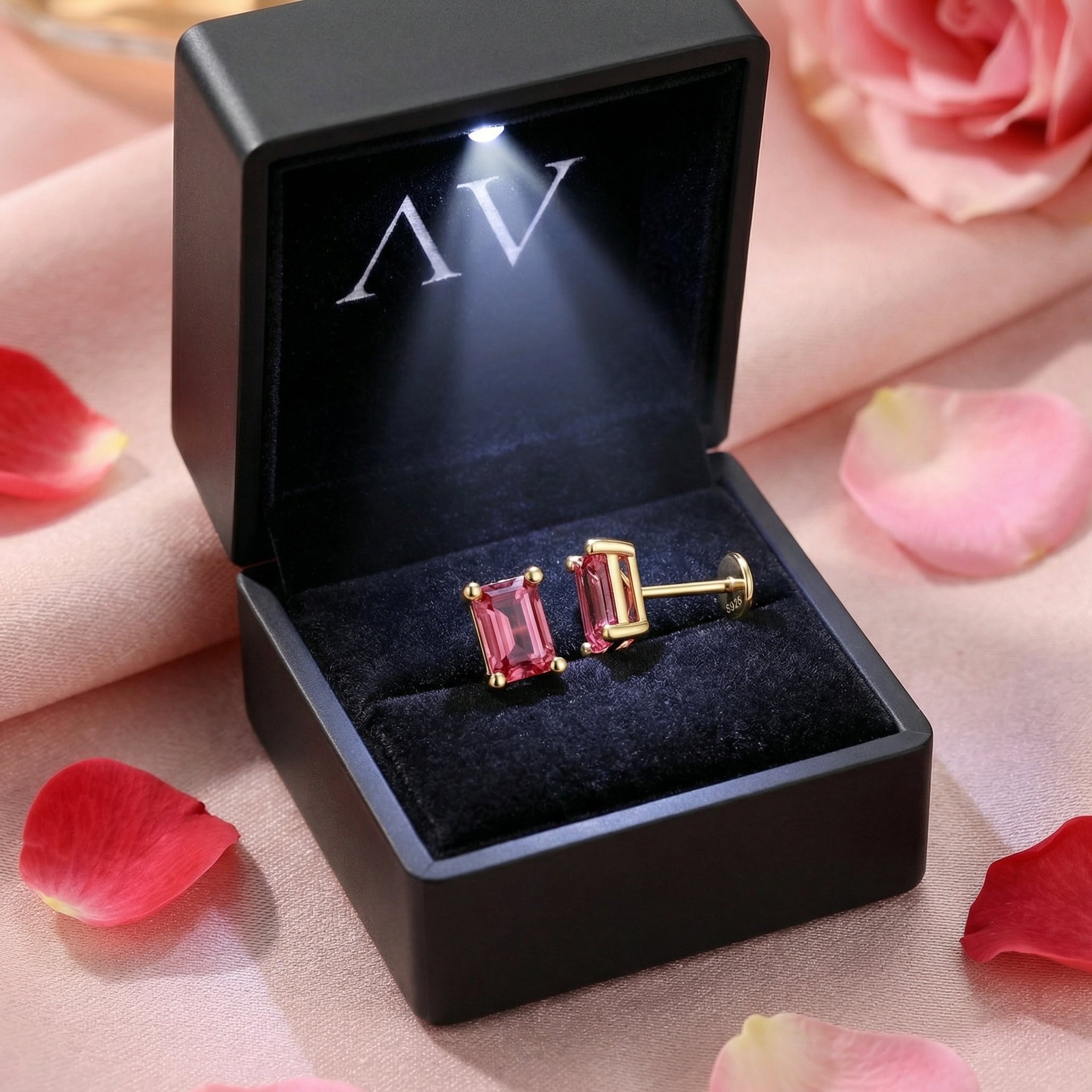Baguette-cut pink tourmaline earrings in 18K gold vermeil inside a lighted black jewelry gift box.