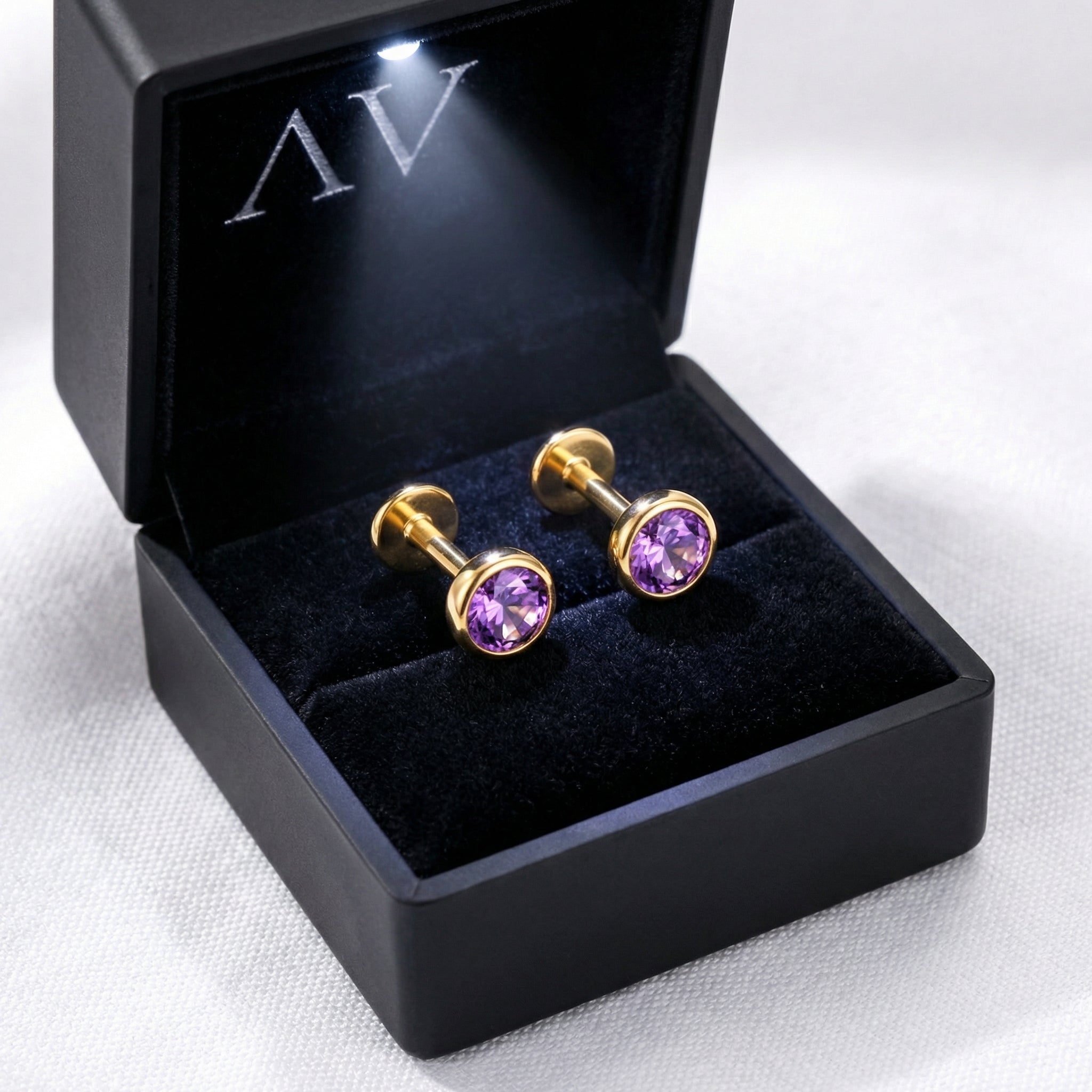 Two 18K gold vermeil simulated amethyst earrings inside a black jewelry box with a built-in LED light.