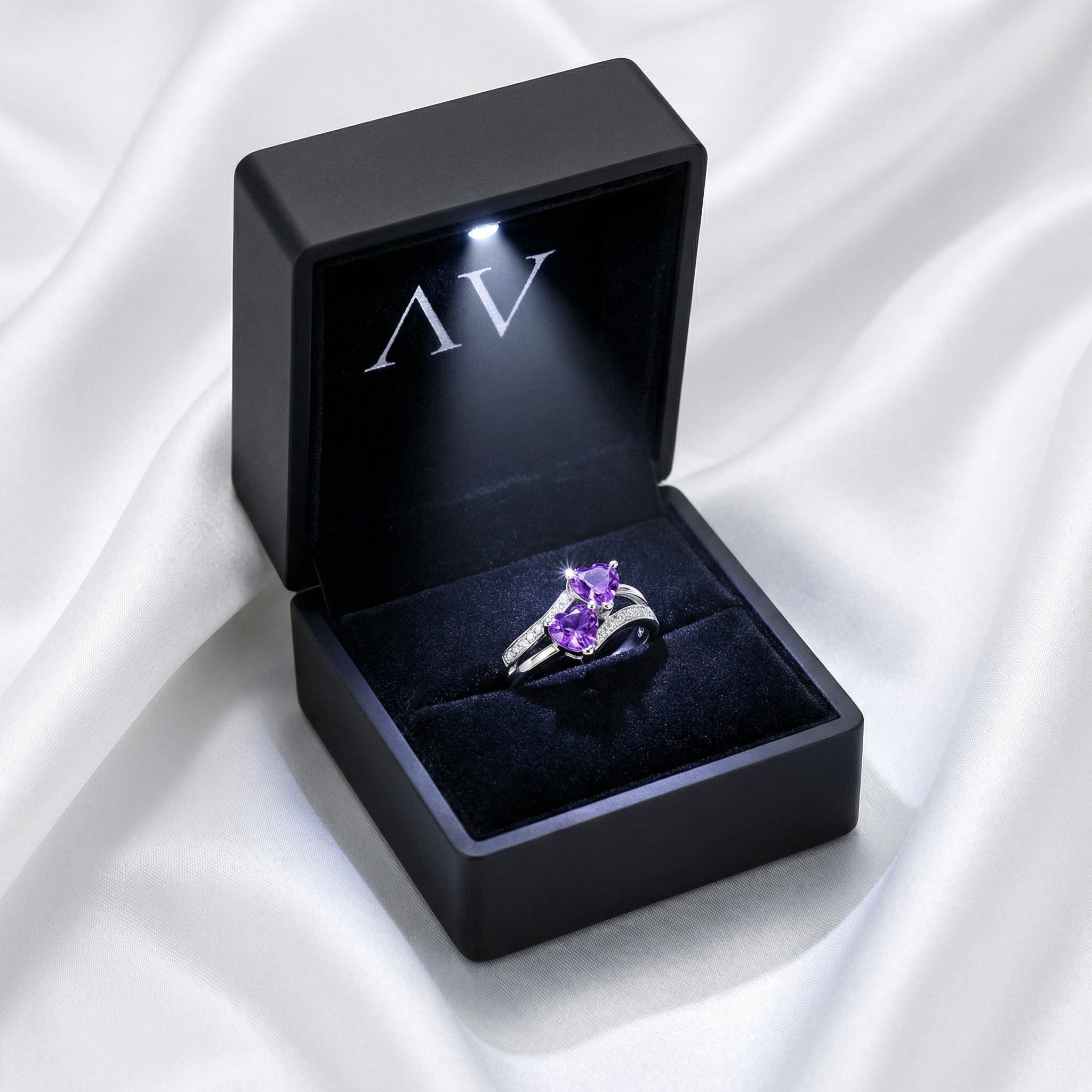 Adara purple heart-cut simulated amethyst ring in S925 sterling silver inside a black LED-lighted box.