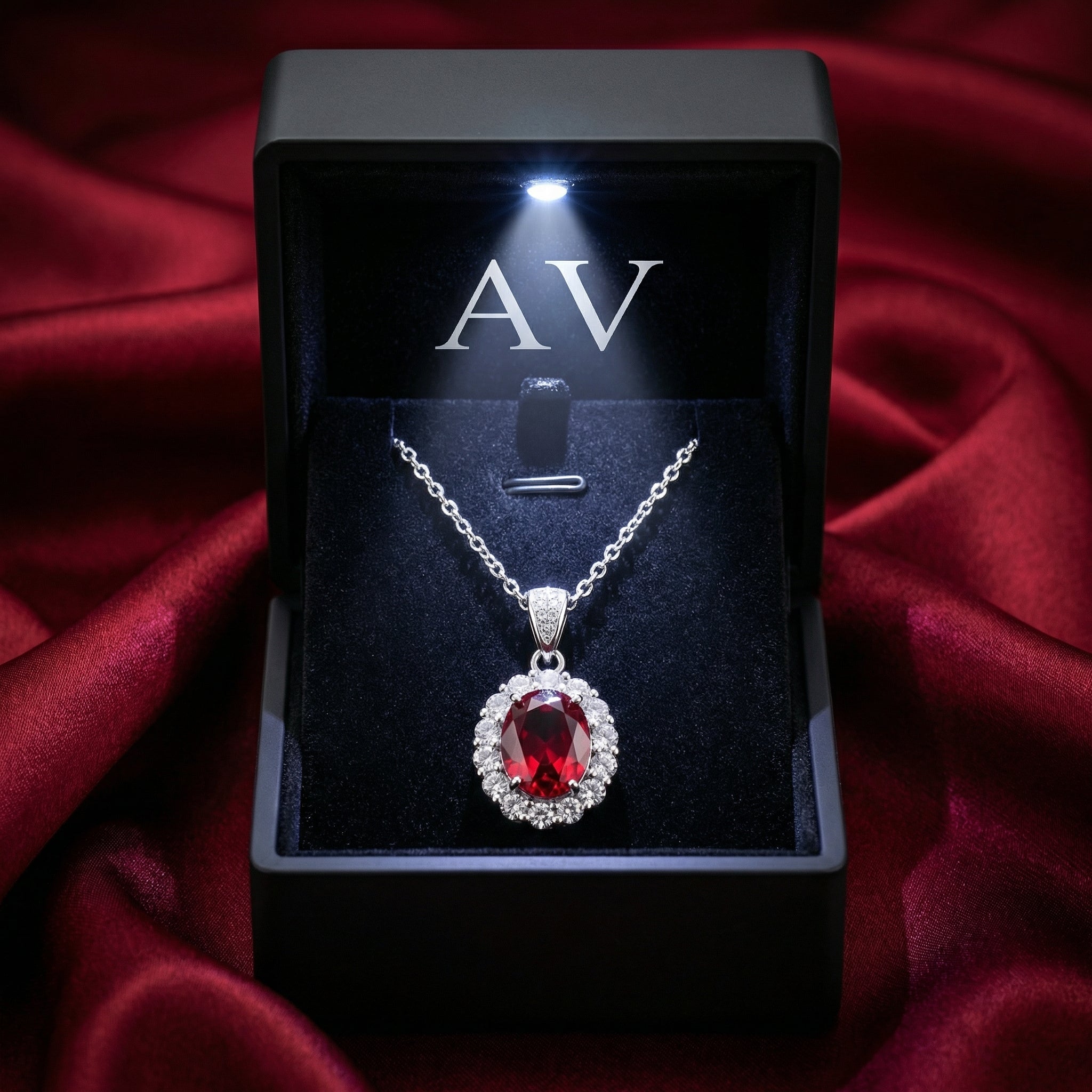 Simulated ruby halo necklace in a premium black LED-lighted gift box on red silk.