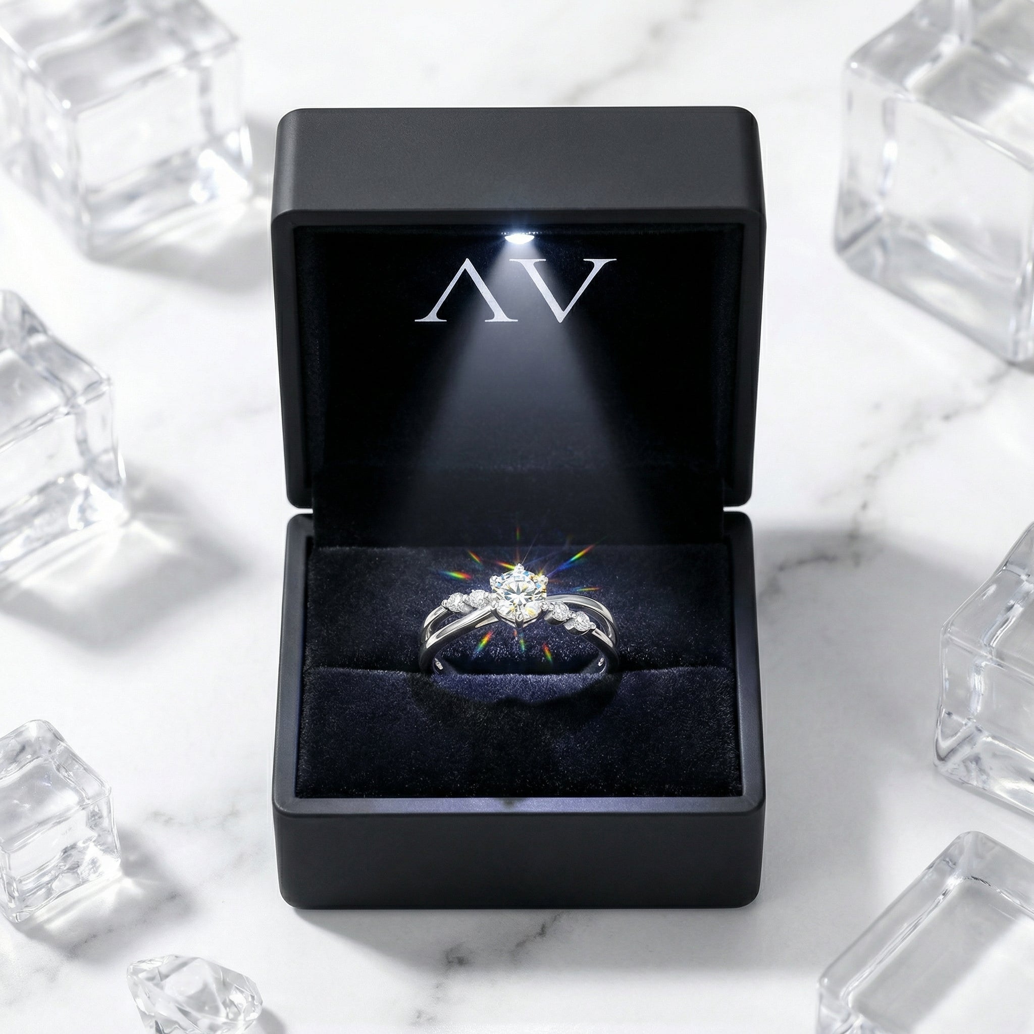 Iseltra S925 sterling silver bypass ring inside a black LED-lit gift box on a marble surface.
