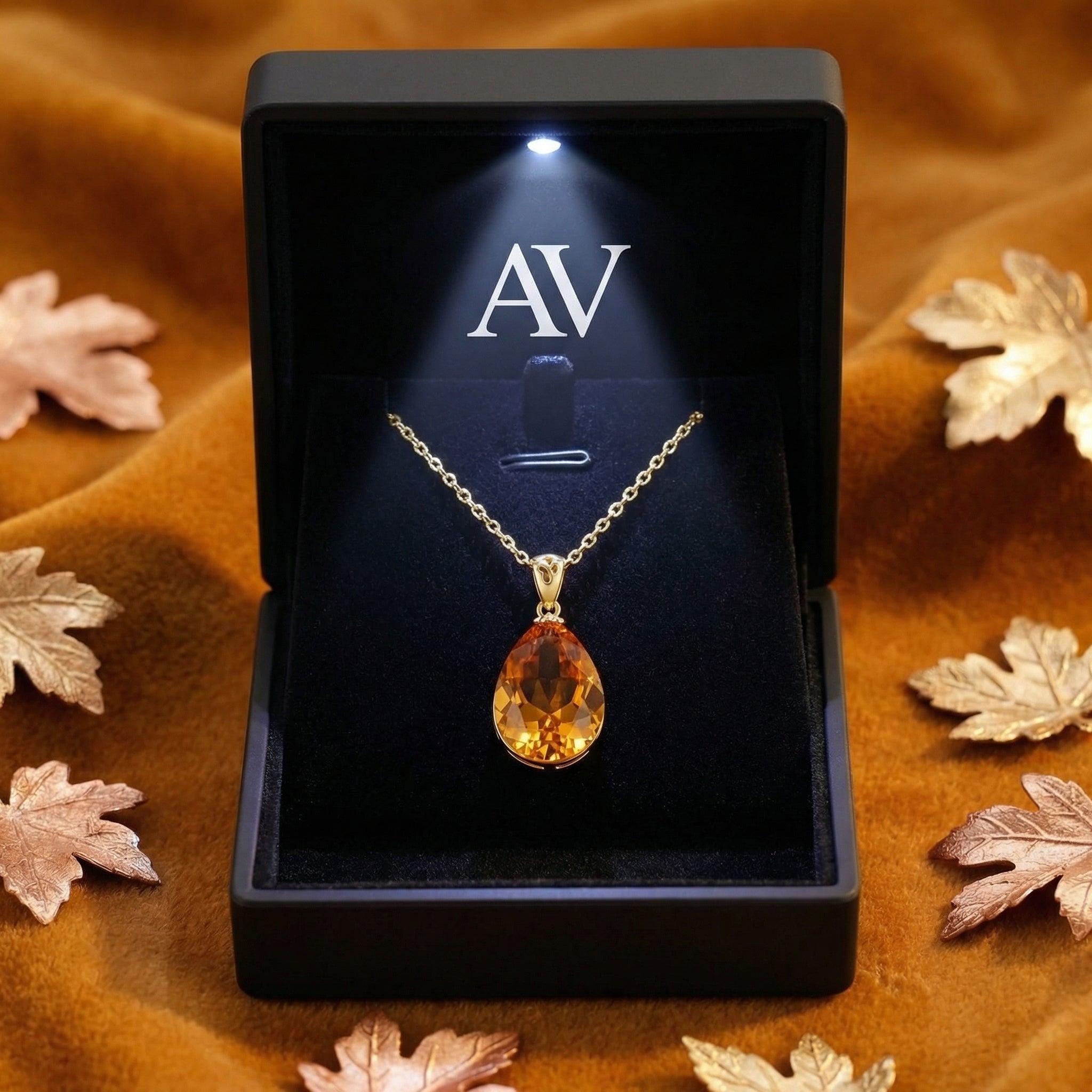 Teardrop simulated topaz necklace in 18K gold vermeil displayed in a black LED-lit jewelry box.