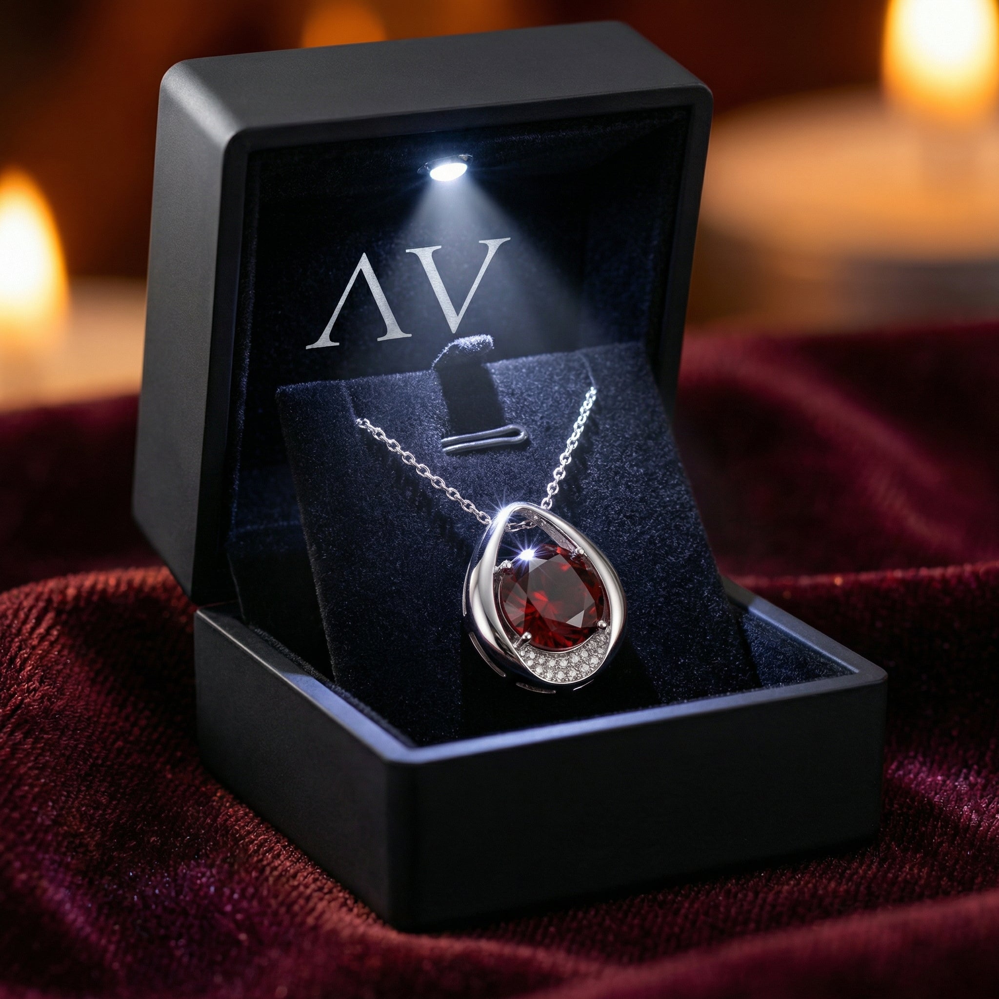 Sterling silver simulated garnet necklace presented in a black LED-lit gift box on a red velvet background.