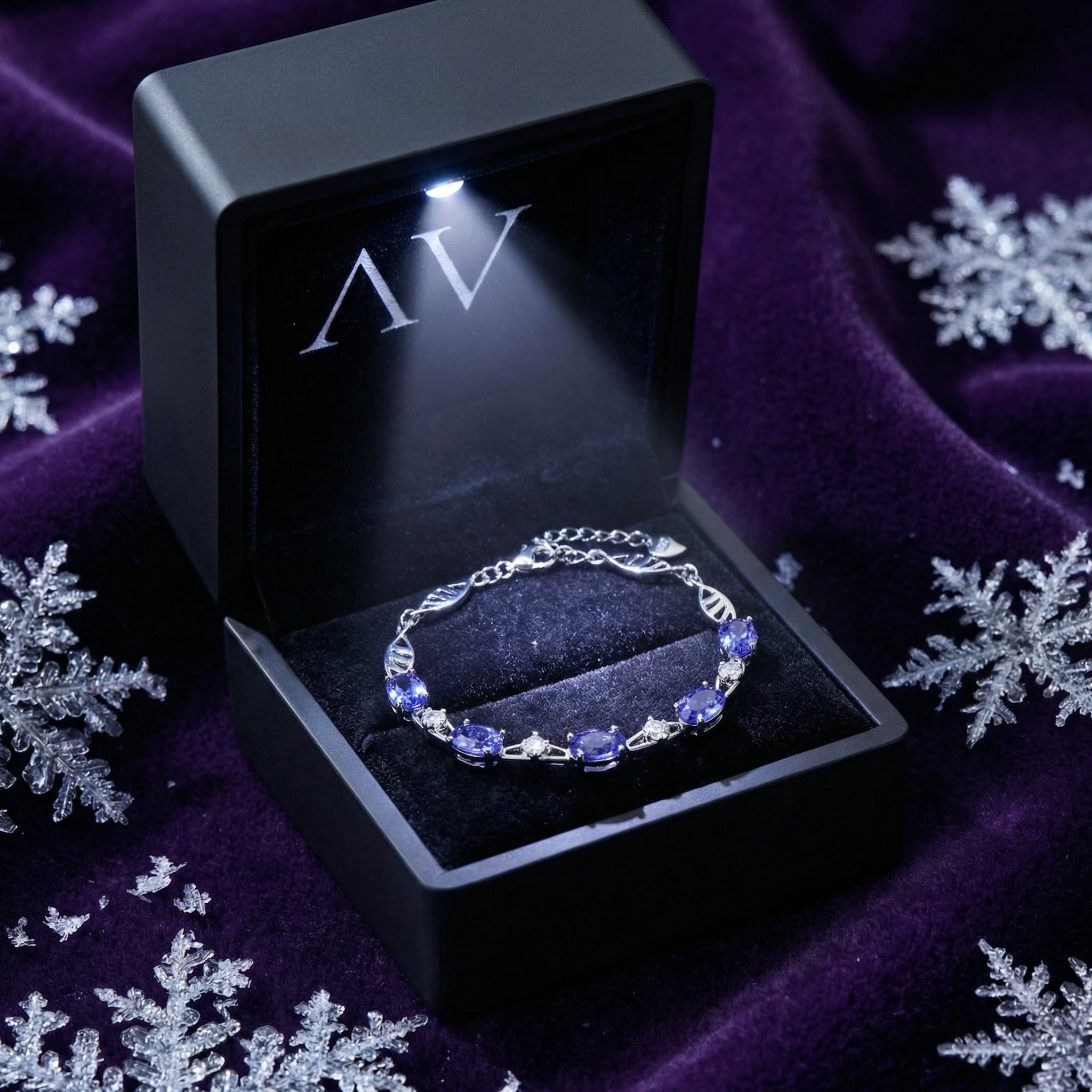 Sterling silver simulated tanzanite station bracelet in a black LED-lighted jewelry presentation box.