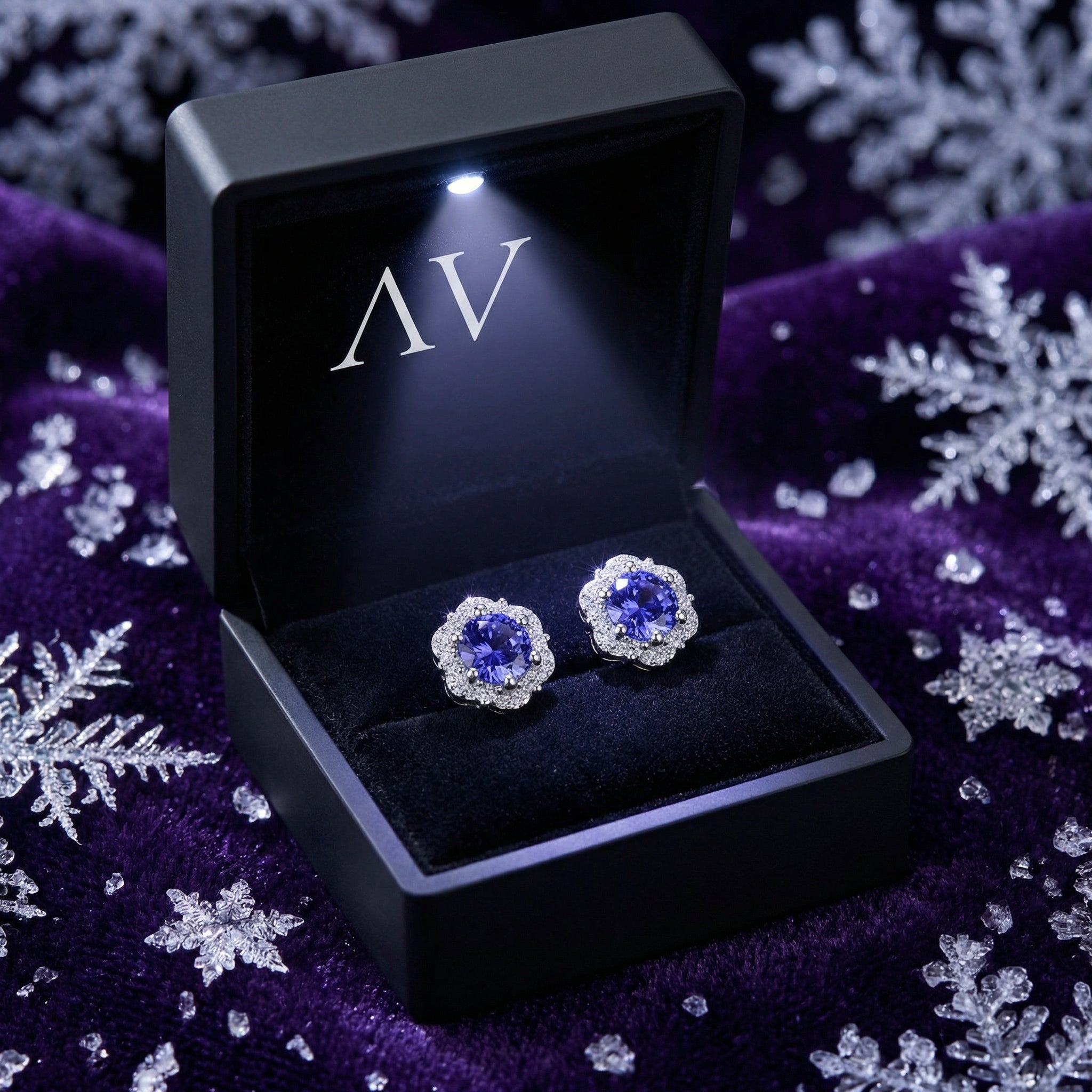 Sidraea Blossom sterling silver and simulated tanzanite earrings presented in a black LED-lit jewelry gift box.