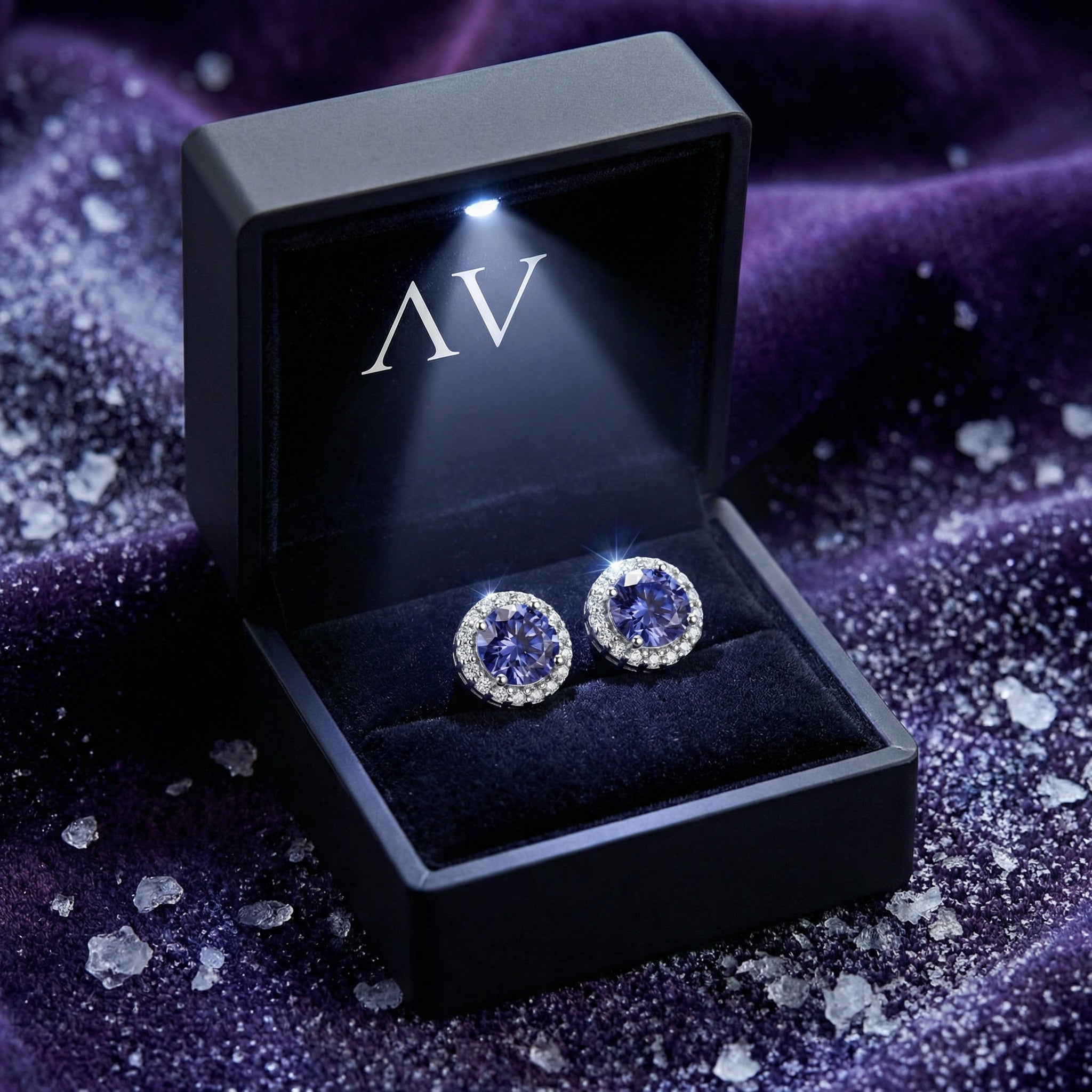 Round blue-violet moissanite halo stud earrings in S925 sterling silver inside a black LED-lit presentation gift box.