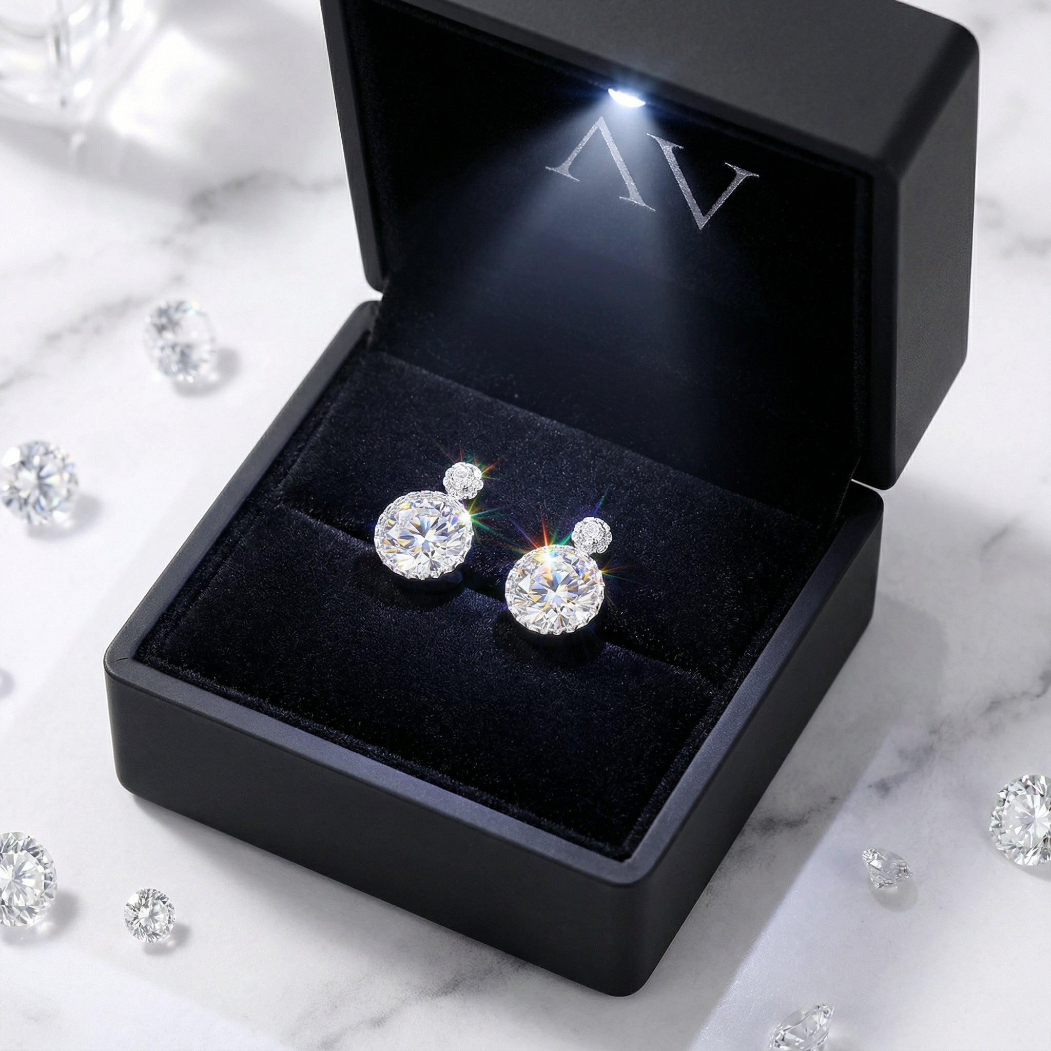 Round cut zirconia studs in S925 sterling silver inside a luxury black LED-lit jewelry box.
