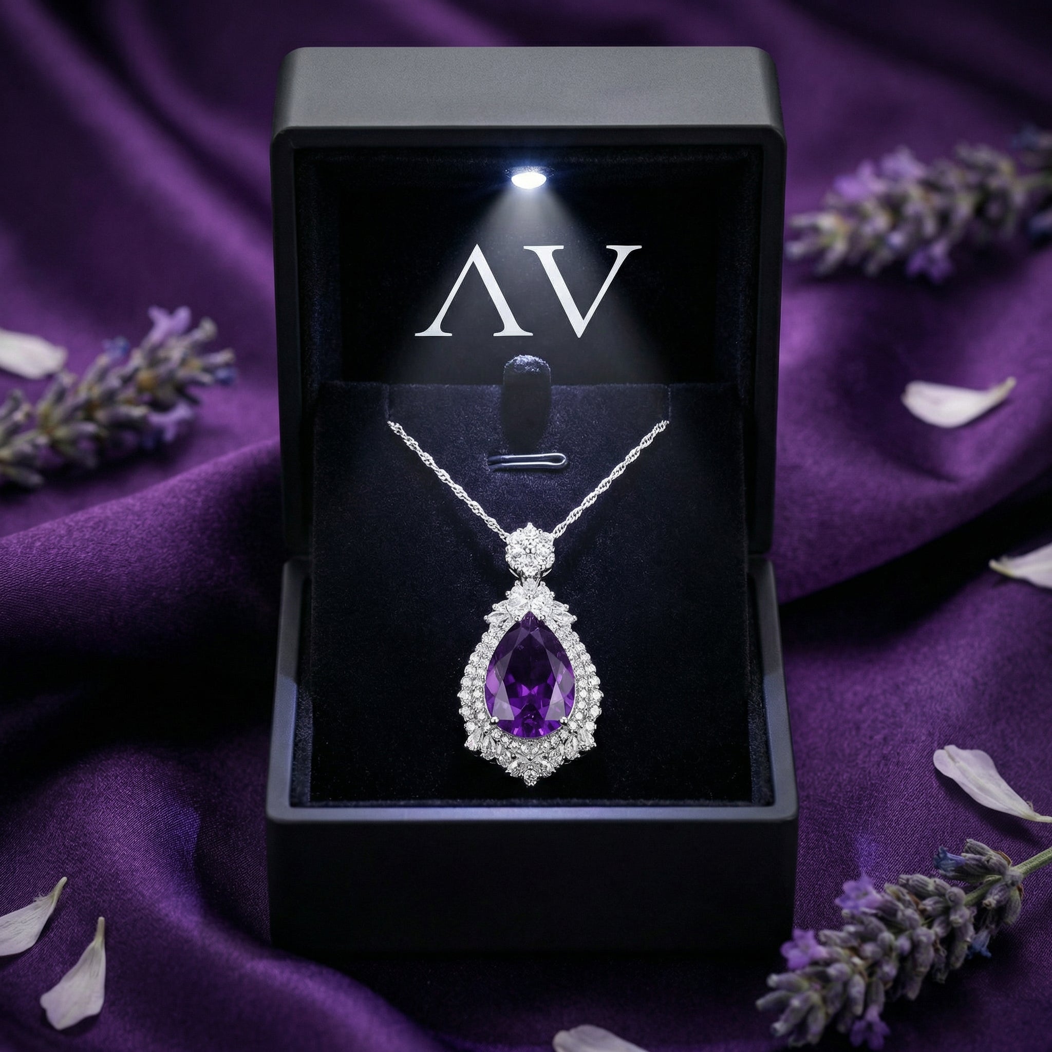 Pear cut amethyst sterling silver necklace in a black lighted gift box on purple silk.