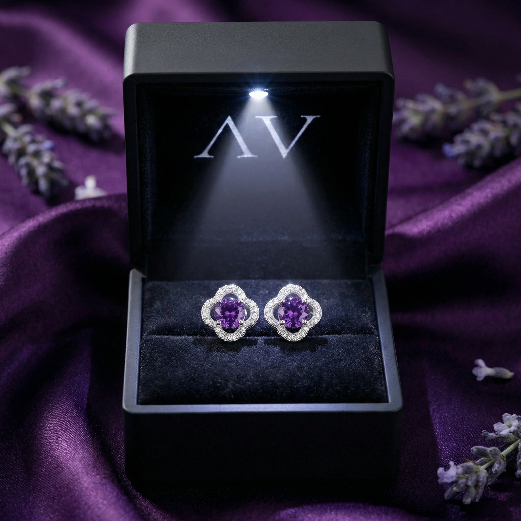 Natural amethyst stud earrings in S925 sterling silver displayed in a black LED-lit jewelry presentation box.