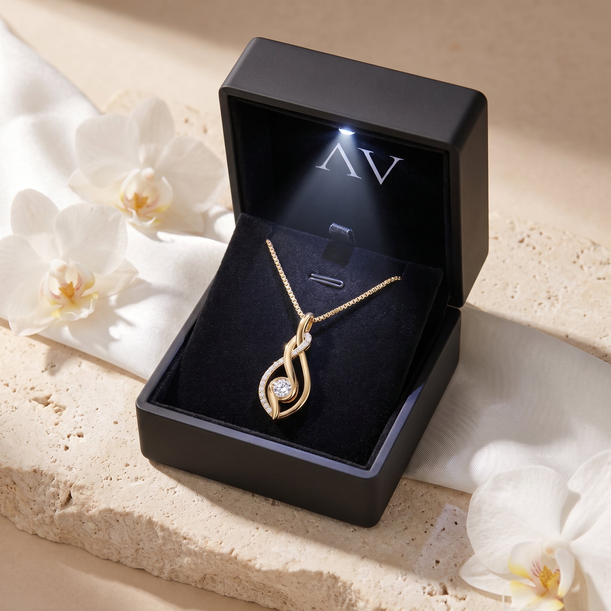 Yellow gold moissanite pendant necklace inside a black LED-lit presentation box.