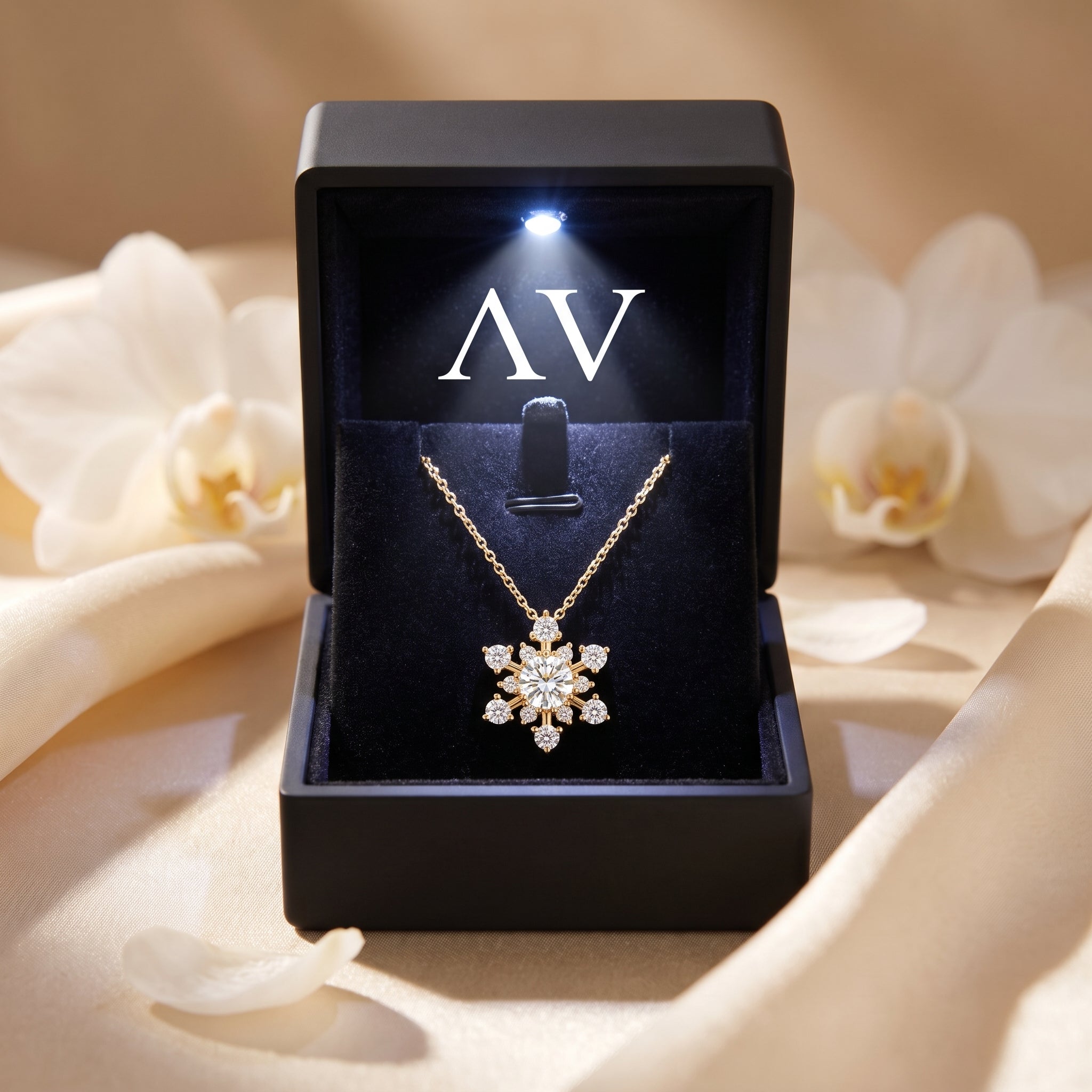 Yellow gold moissanite snowflake necklace inside a black LED-lit presentation gift box.